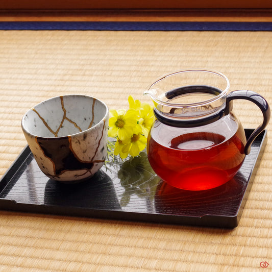 Photo of an authentic Kintsugi pottery piece being used in a real-world setting,