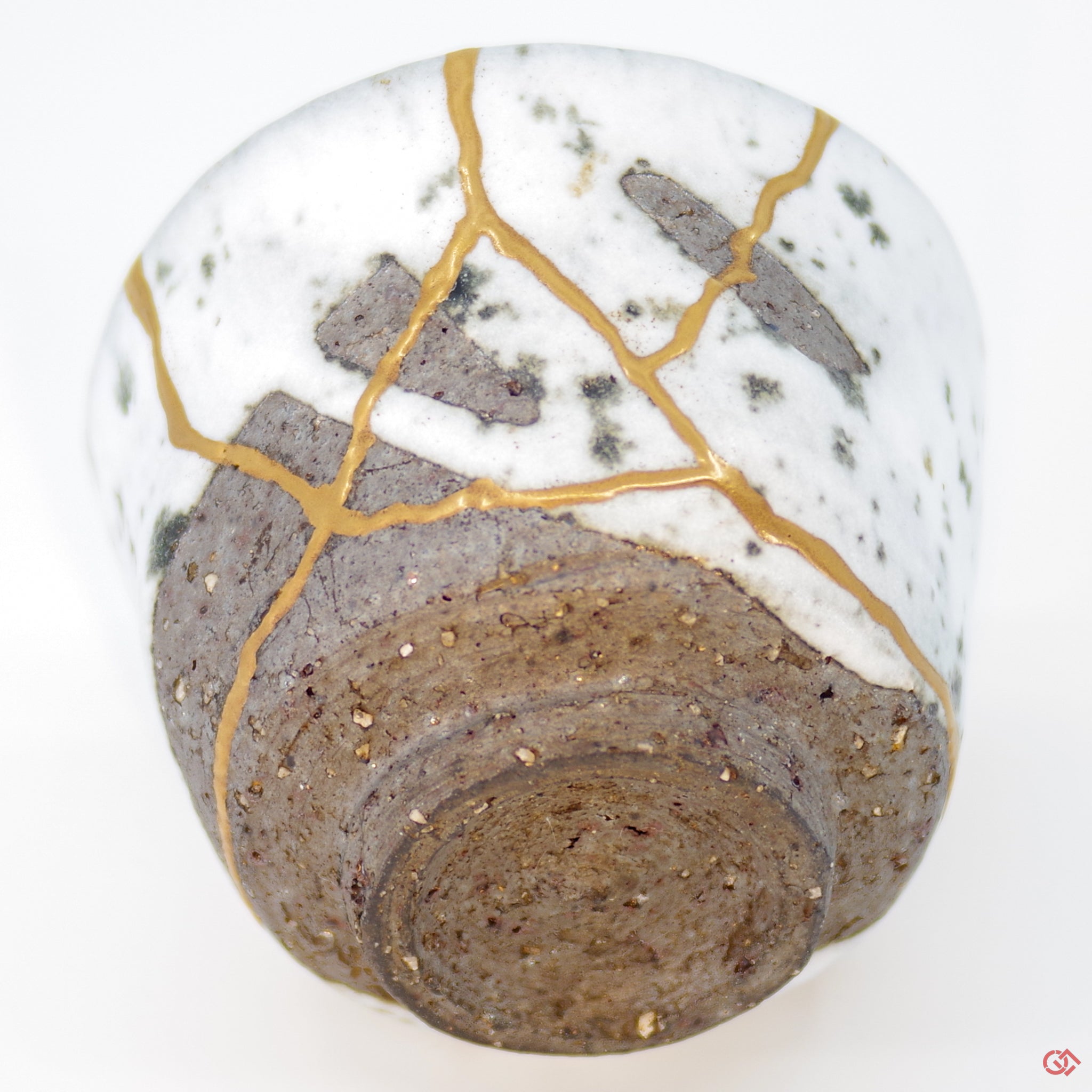 Close-up photo of an authentic Kintsugi pottery piece, showing the detail of its repairs and craftsmanship
