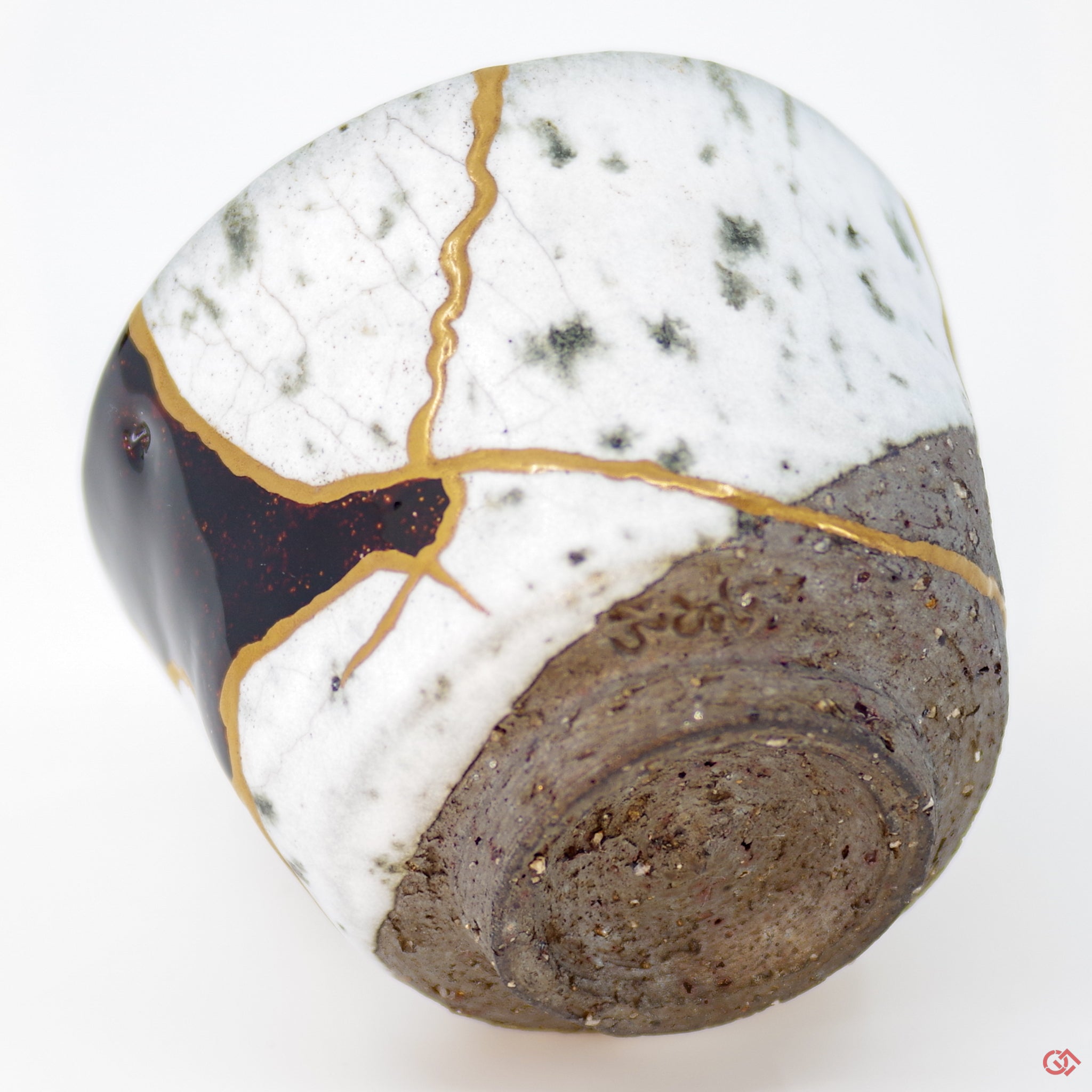 Close-up photo of an authentic Kintsugi pottery piece, showing the detail of its repairs and craftsmanship