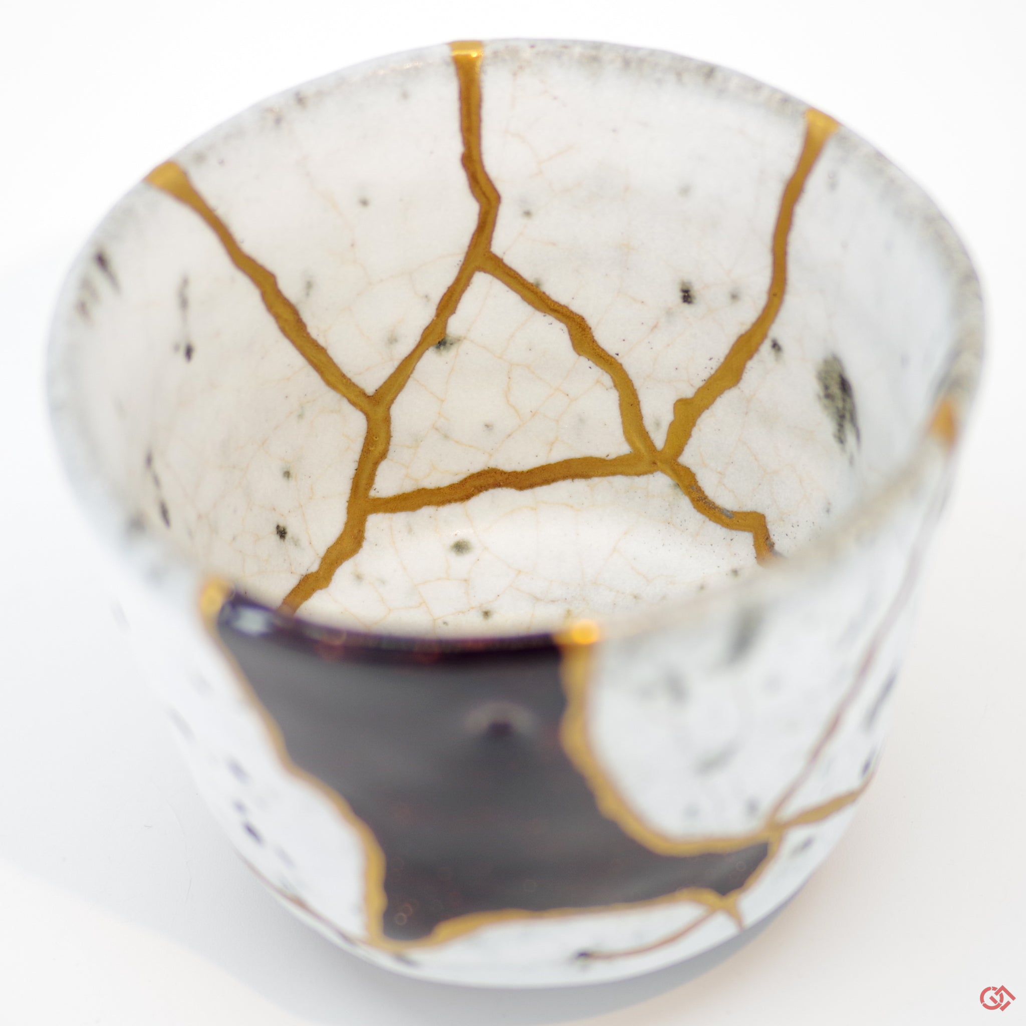 Close-up photo of an authentic Kintsugi pottery piece, showing the detail of its repairs and craftsmanship