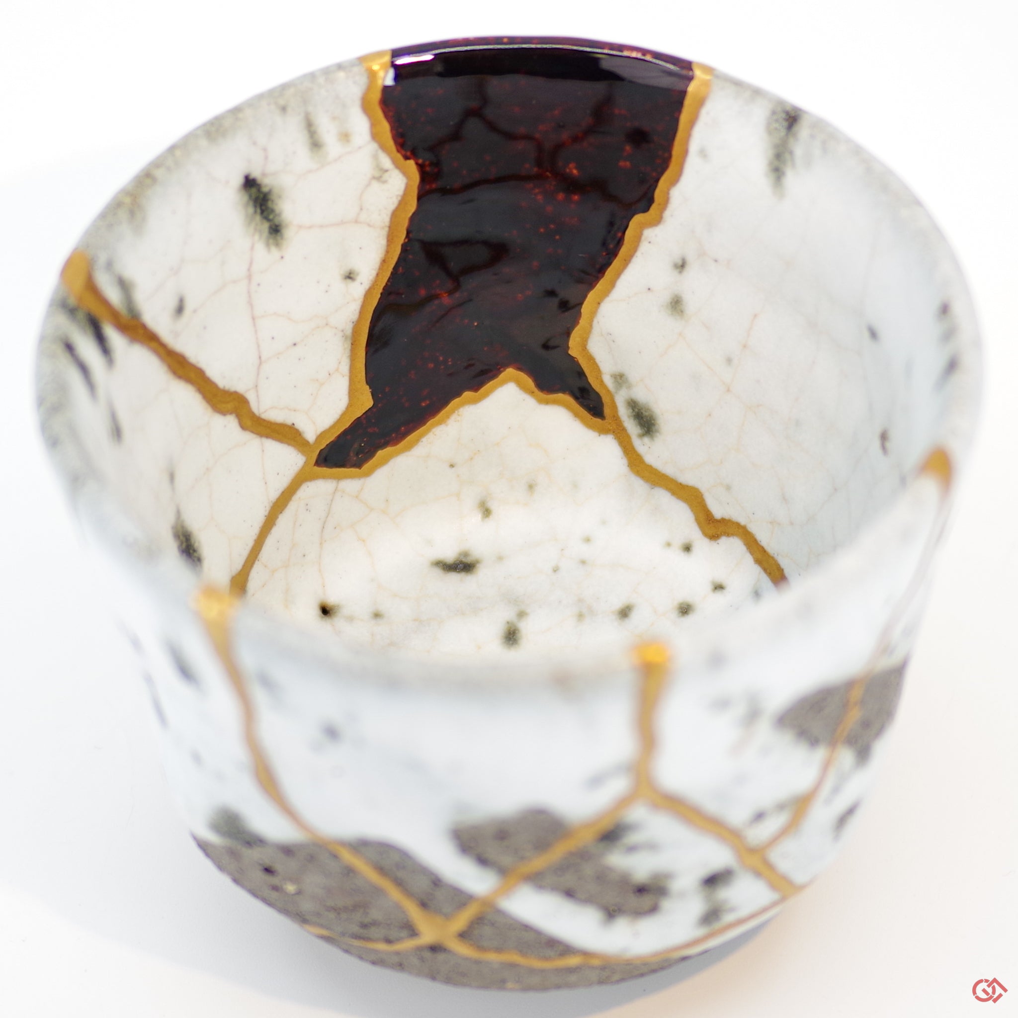 Close-up photo of an authentic Kintsugi pottery piece, showing the detail of its repairs and craftsmanship