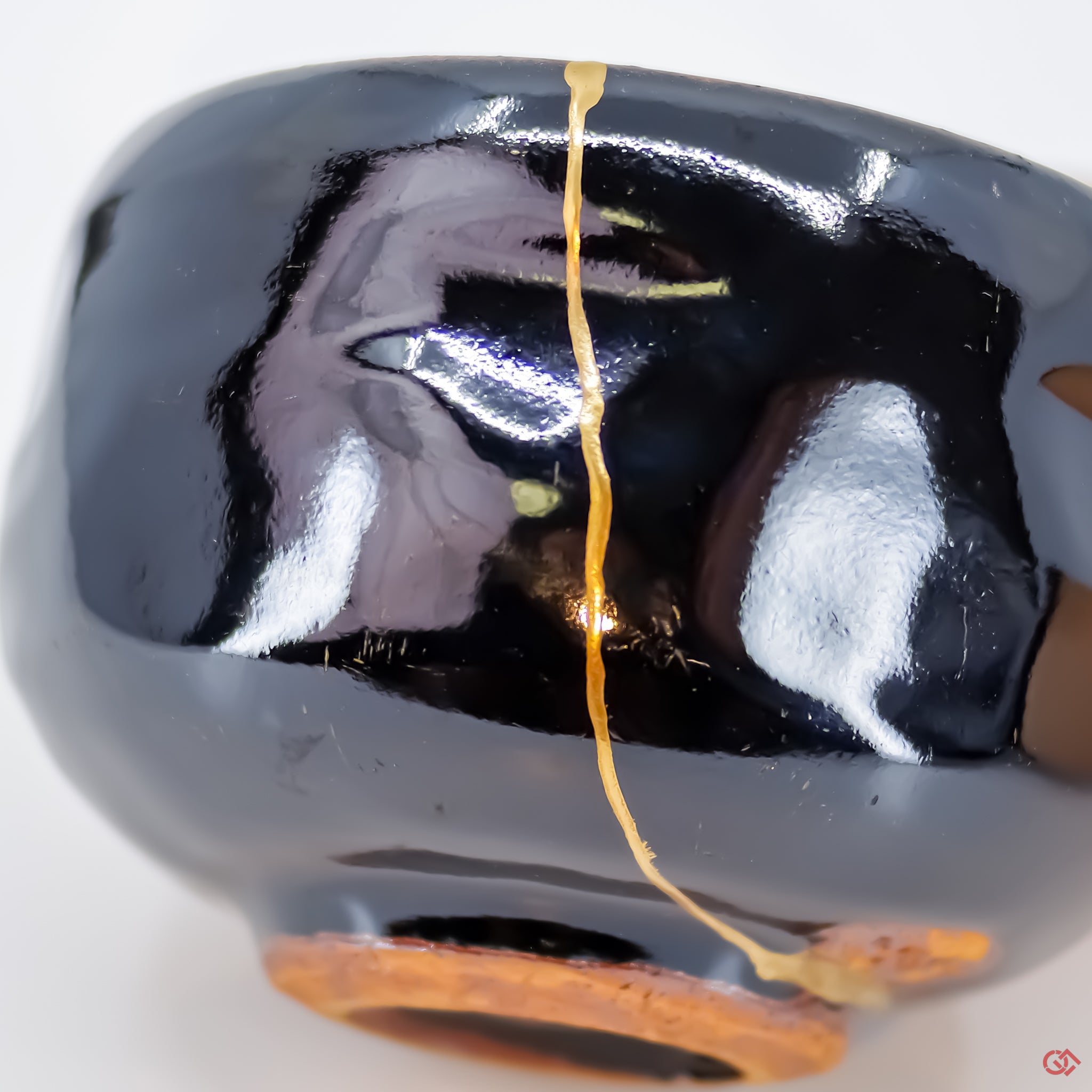 Close-up photo of an authentic Kintsugi pottery piece, showing the detail of its repairs and craftsmanship