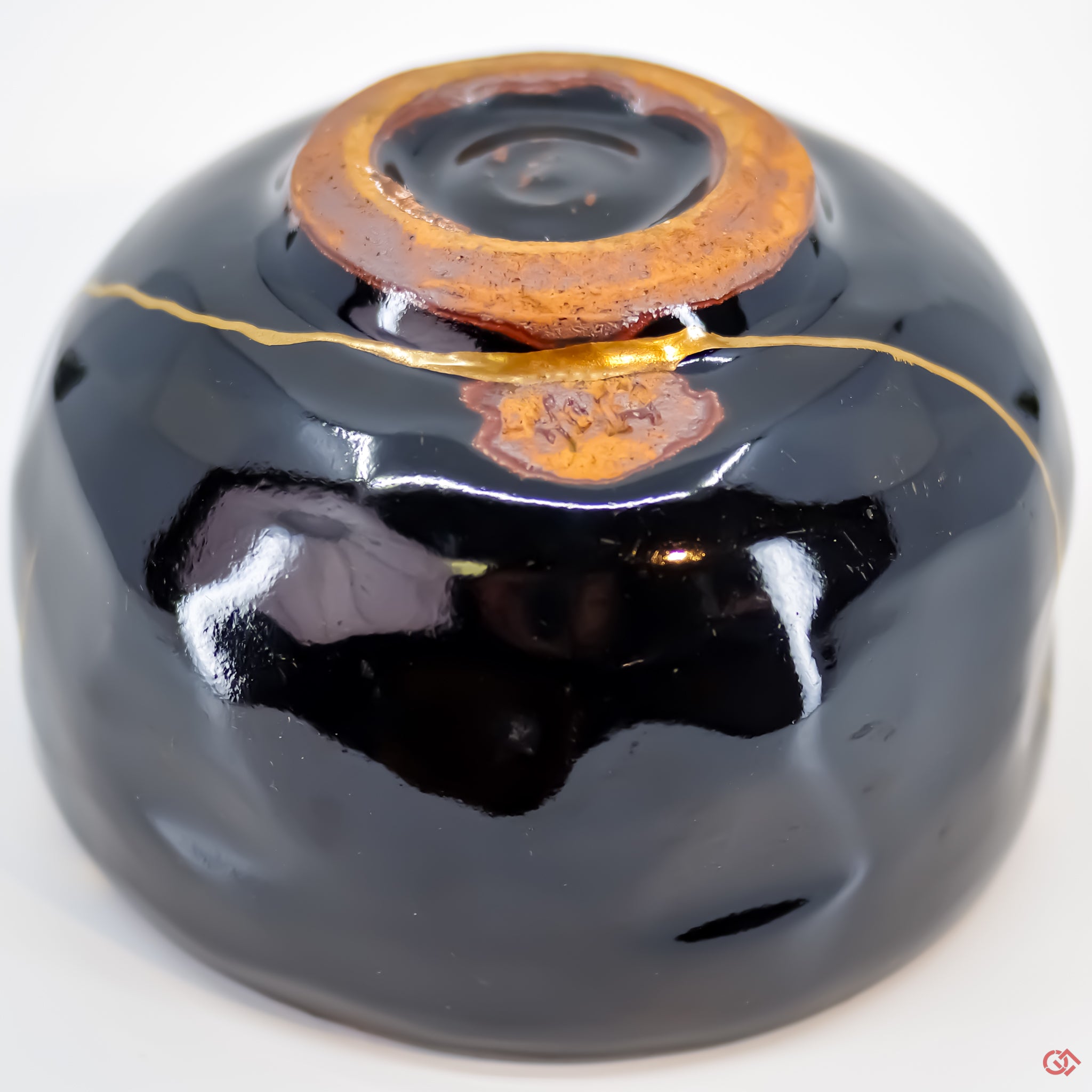 Close-up photo of an authentic Kintsugi pottery piece, showing the detail of its repairs and craftsmanship