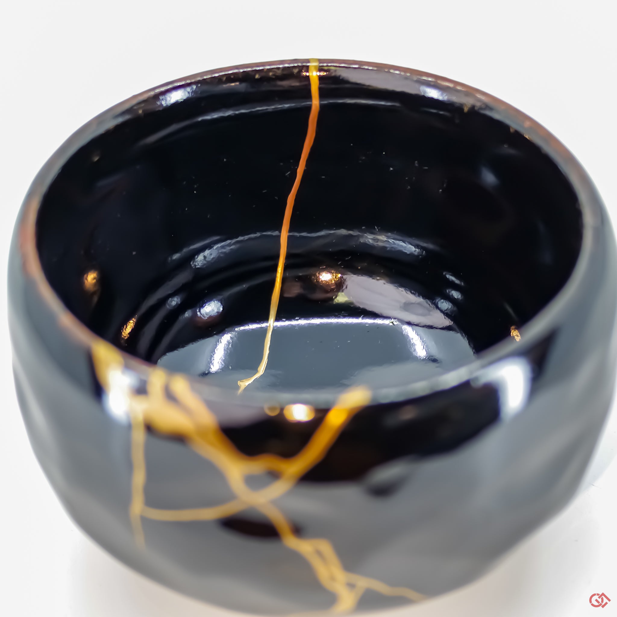 Close-up photo of an authentic Kintsugi pottery piece, showing the detail of its repairs and craftsmanship