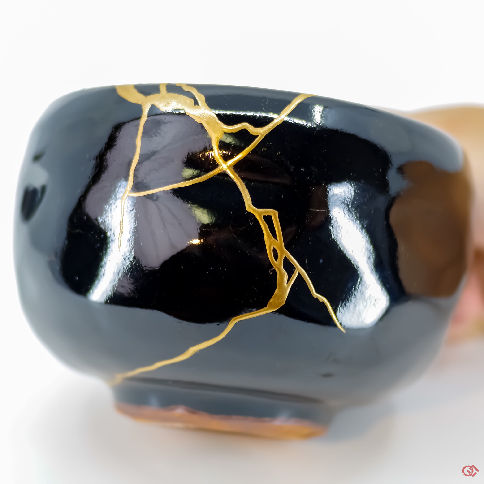 Close-up photo of an authentic Kintsugi pottery piece, showing the detail of its repairs and craftsmanship