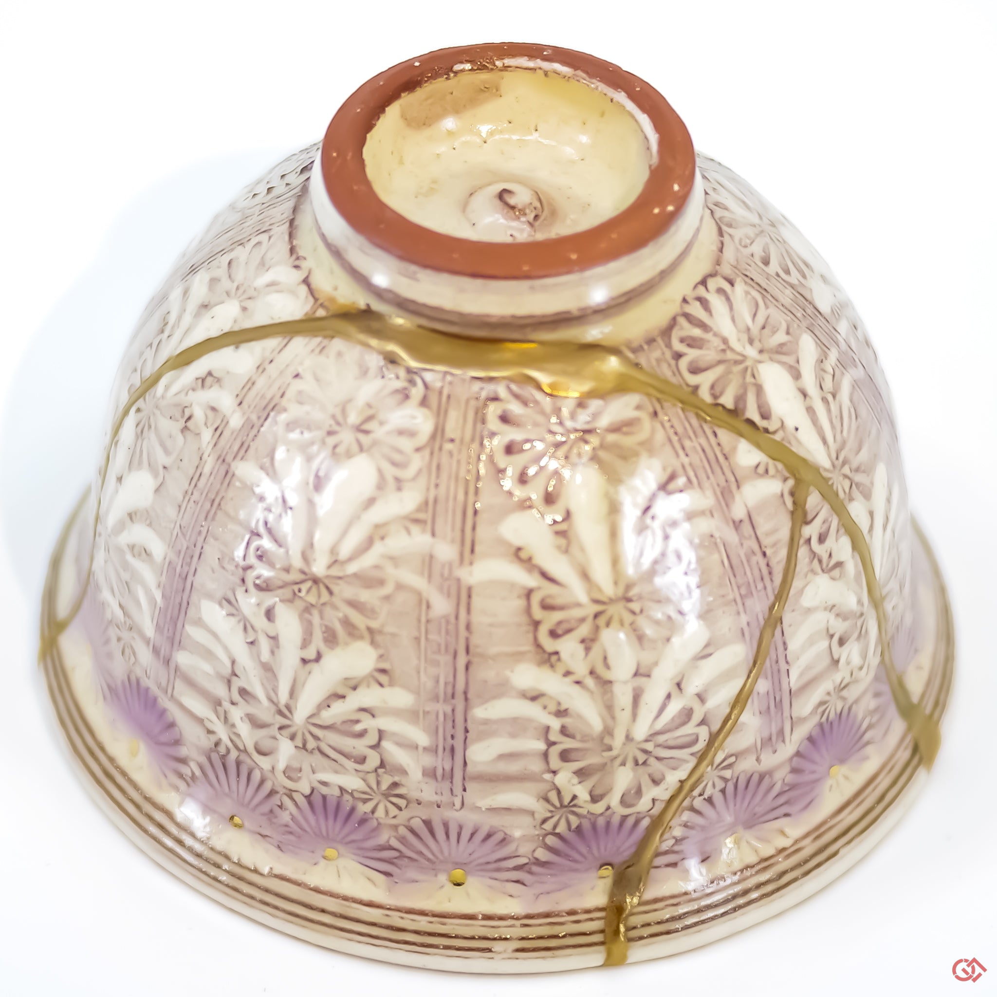 Close-up photo of an authentic Kintsugi pottery piece, showing the detail of its repairs and craftsmanship