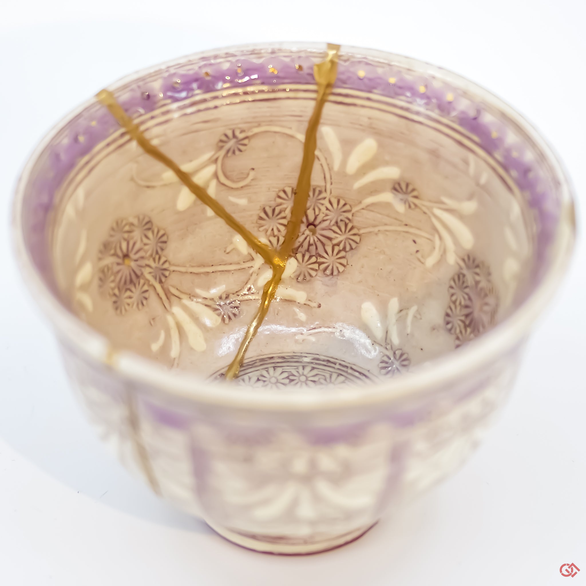 Close-up photo of an authentic Kintsugi pottery piece, showing the detail of its repairs and craftsmanship