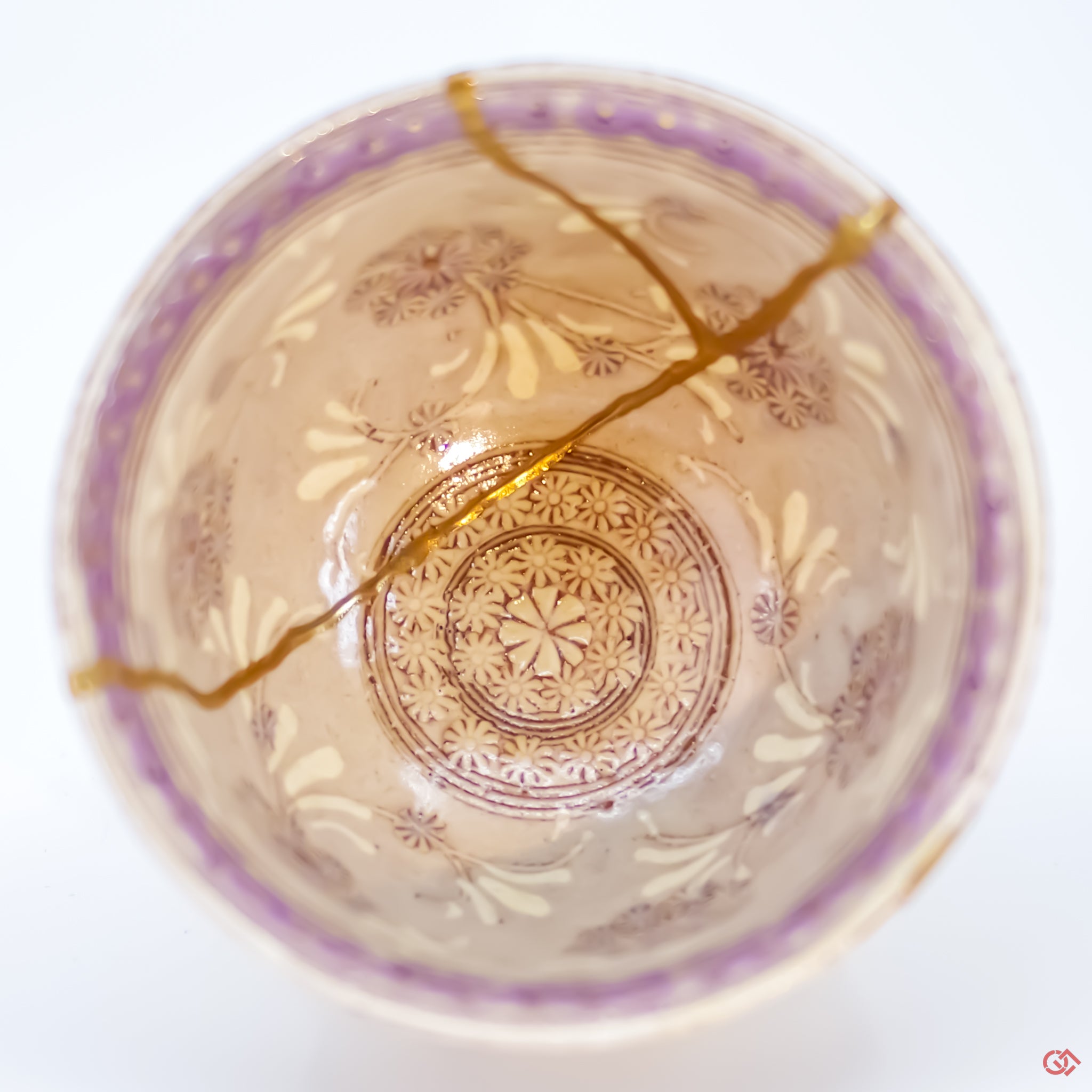 Close-up photo of an authentic Kintsugi pottery piece, showing the detail of its repairs and craftsmanship