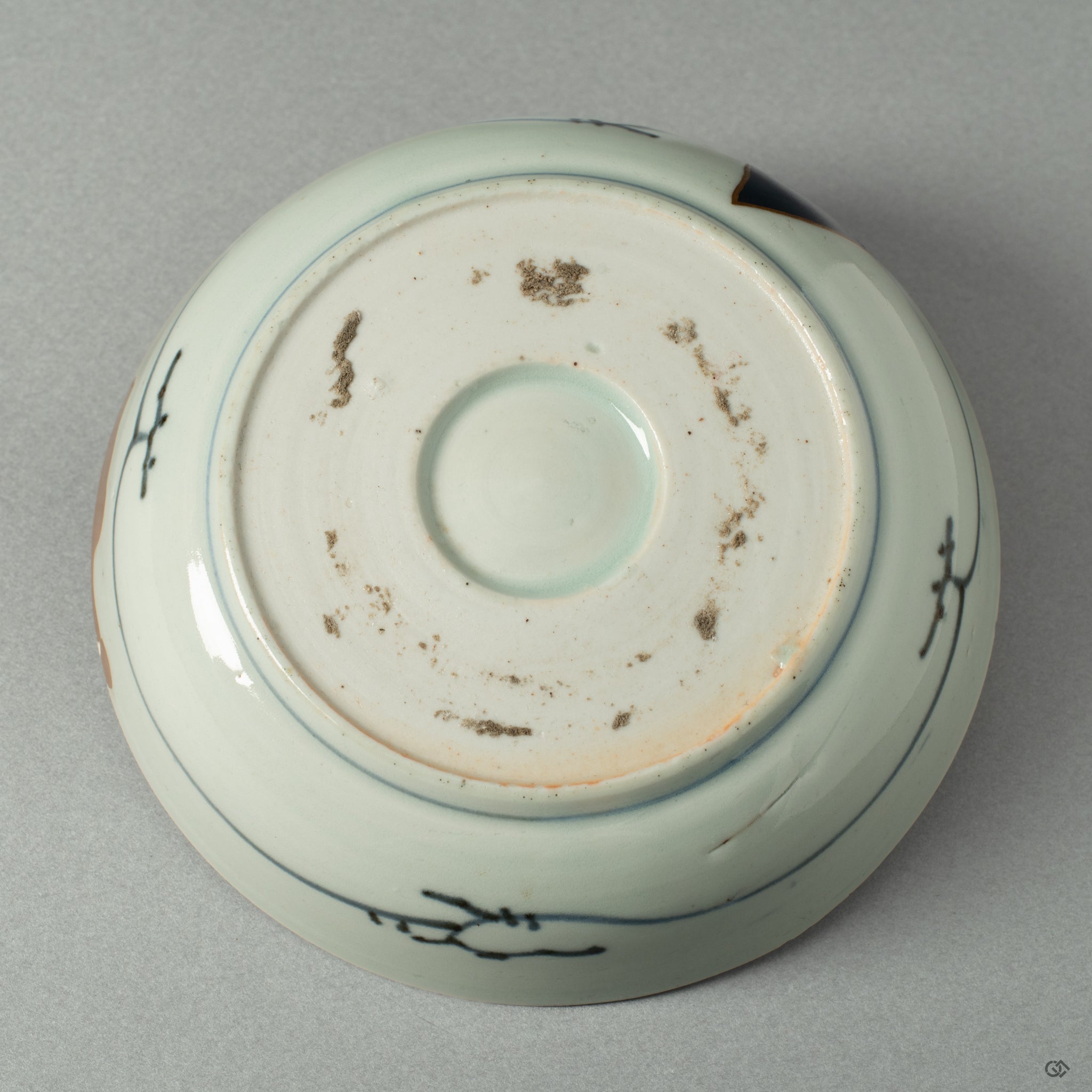 The underside of the Ko-Imari bowl, showing the potter's mark and the quiet integrity of its form, a foundation for its artistic rebirth.