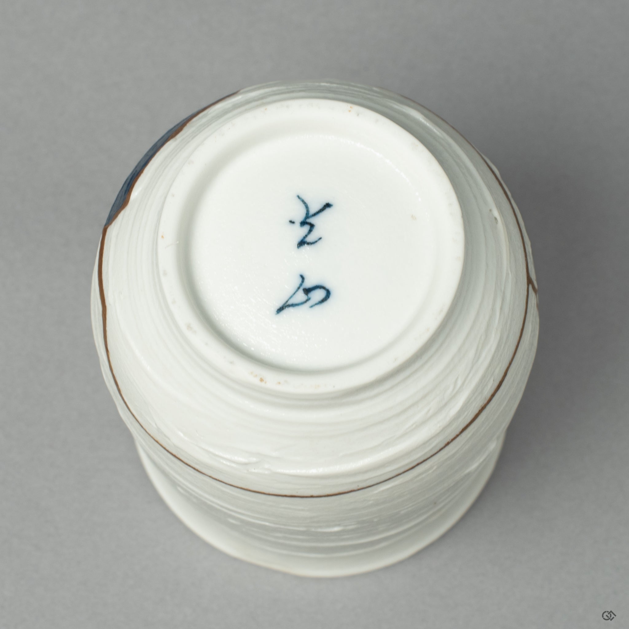 The underside of the Nabeshima ware cup, showing the authentic potter's mark, a foundation for its artistic rebirth through Kintsugi and Urushi-e.