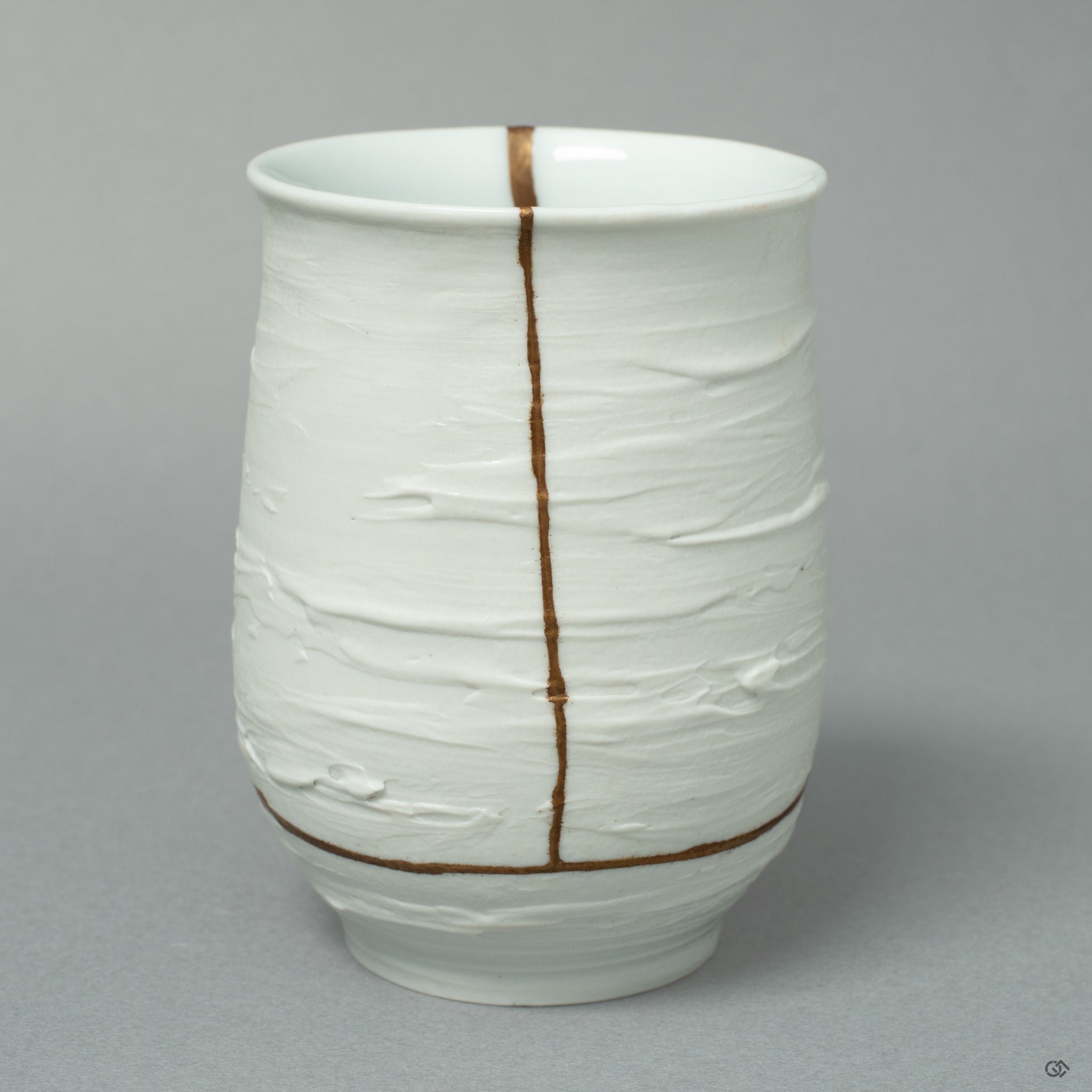 A close-up on the golden seam, not as a flaw, but as a revered scar that honors the vessel's unique history and its graceful rebirth.