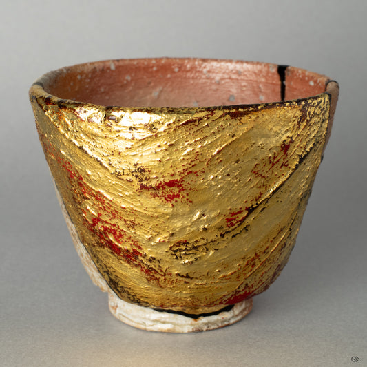 A close-up on the earthy, unglazed surface of the Shigaraki ware kintsugi, where the gold leaf repair meets the clay, creating a tactile history of the cup.