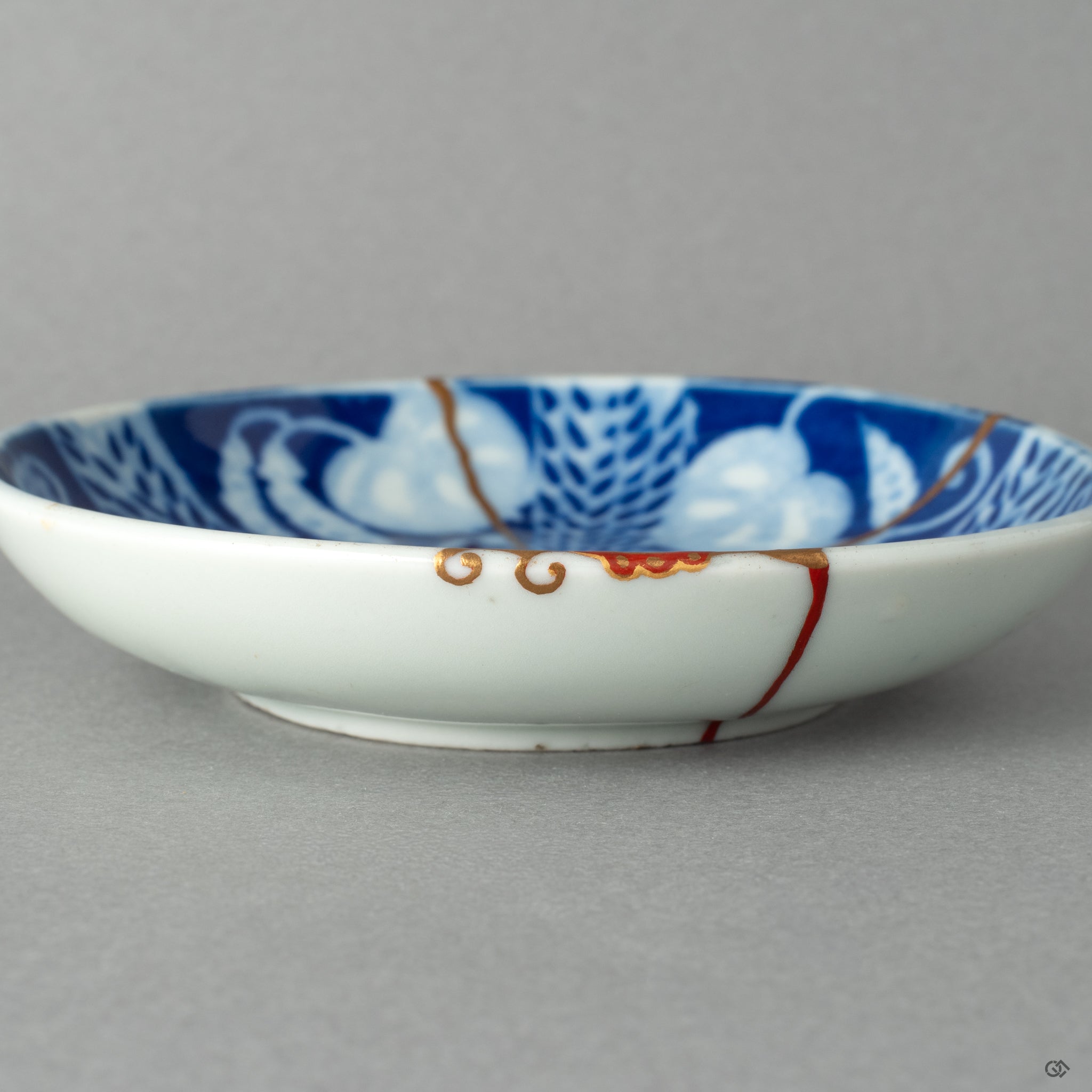 A close-up of the delicate kintsugi repair and Maki-e peas, showcasing a playful new story to tell and the grace in flaws.