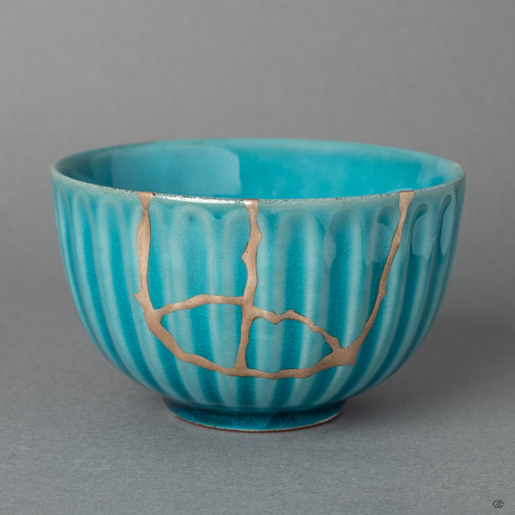 The elegant form of an Arita ware porcelain sake cup, its story honored by the quiet luster of fine silver Kintsugi seams.