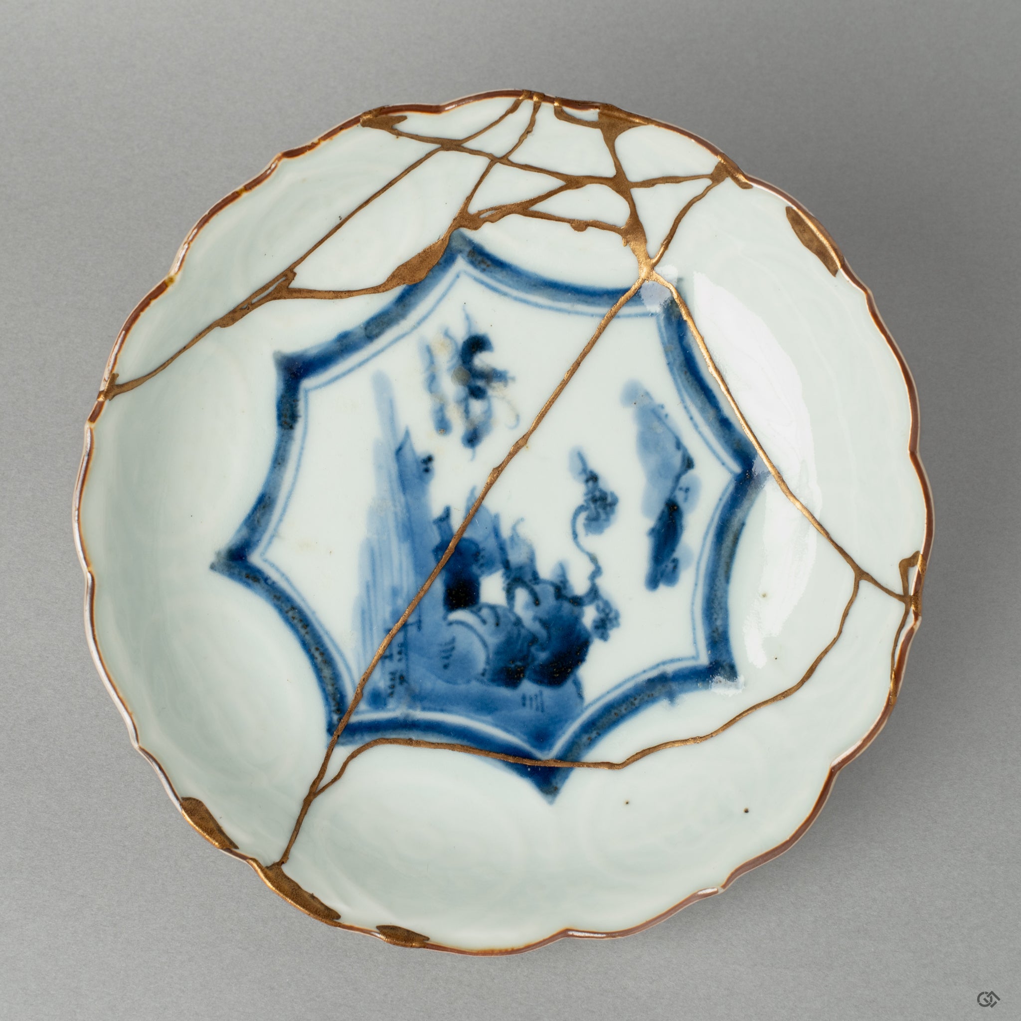 A top-down view into a Ko-Imari bowl, revealing the path of its gold and iro-urushi kintsugi repair, a quiet meditation on beauty in imperfection.