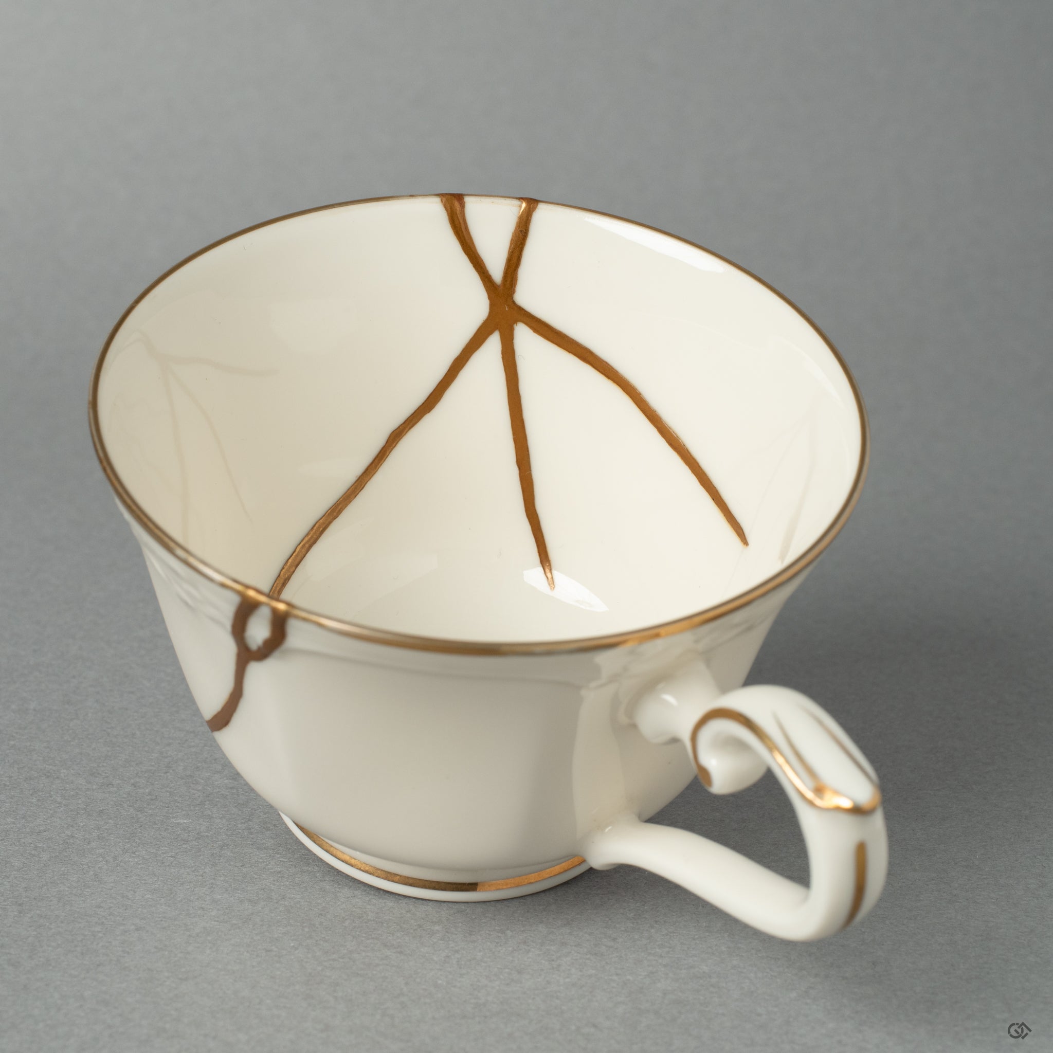 A close-up on a golden seam, revealing the delicate texture where Japanese Urushi lacquer meets 24k gold.