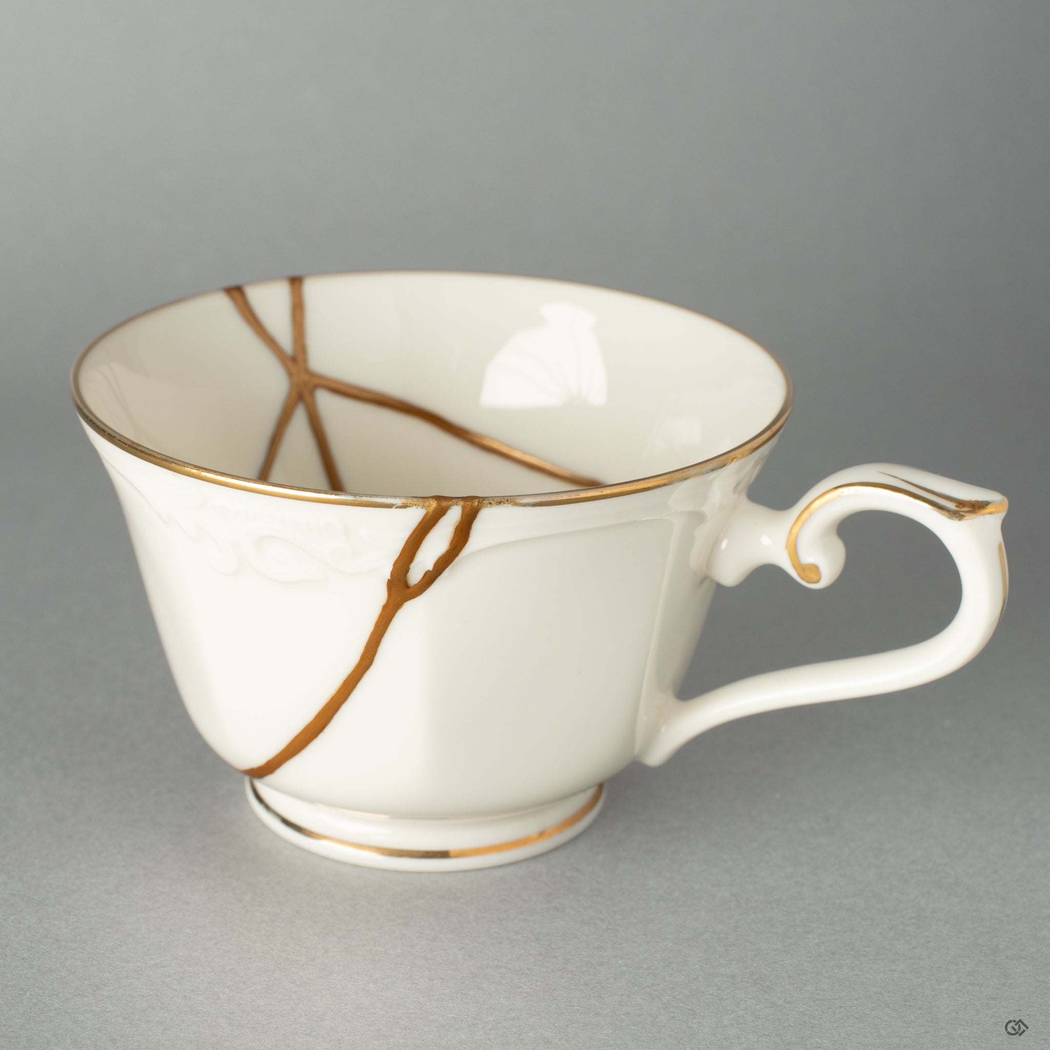 The path of a 24k gold kintsugi river, celebrating the philosophy of finding beauty in an object's unique history.