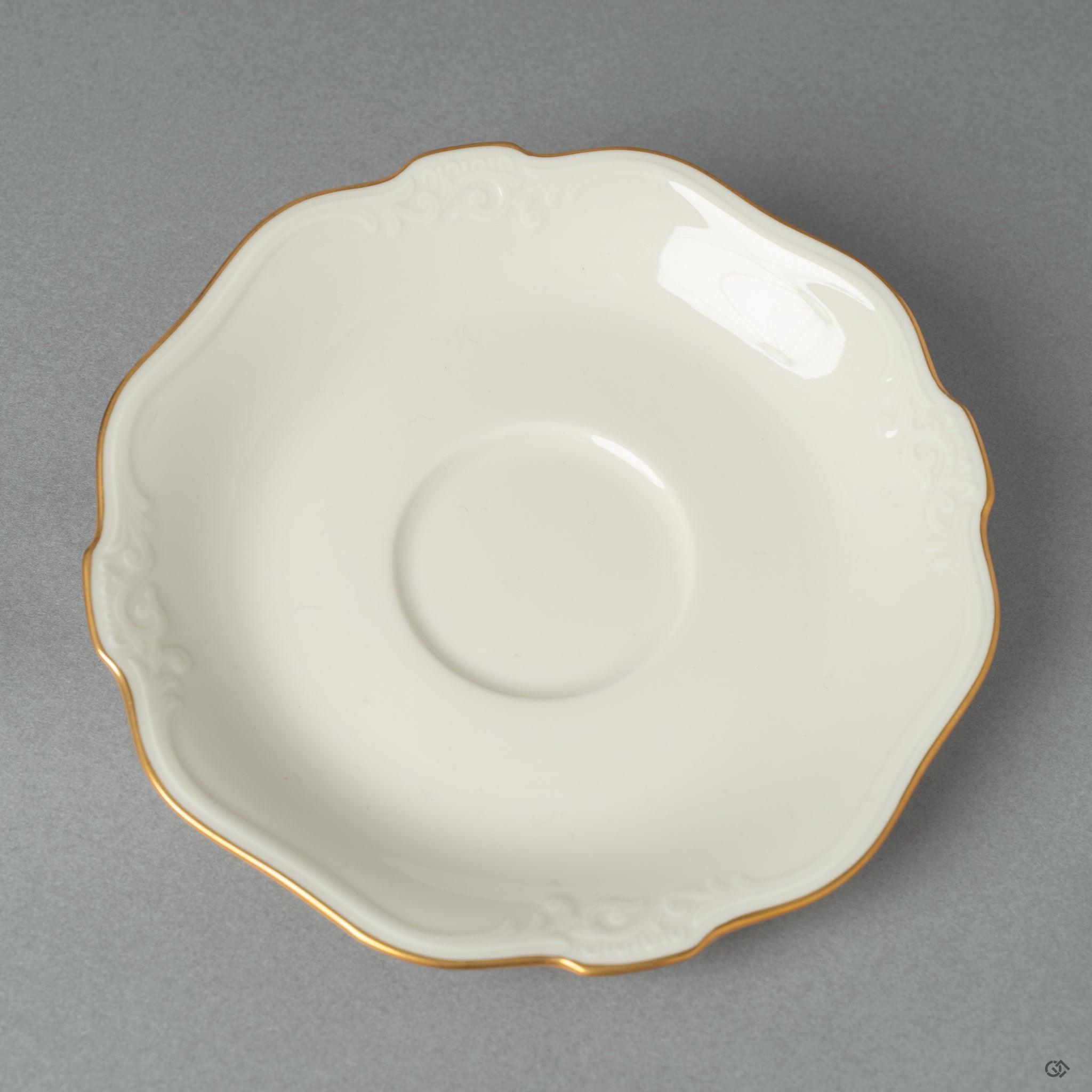 A top view of a white Noritake saucer.