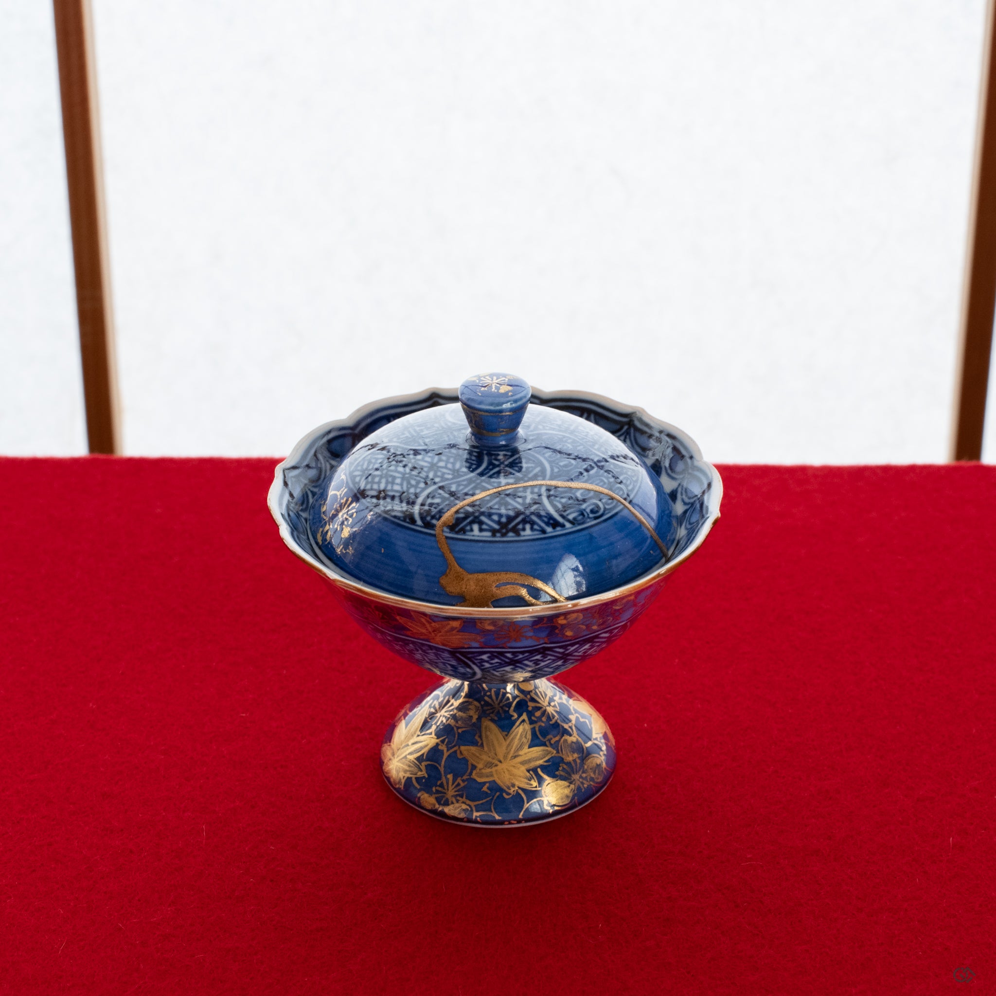 A Kyoto ware kintsugi lidded cup resting on a tatami mat, its 24K gold repair glowing softly, a perfect vessel for intentional living.