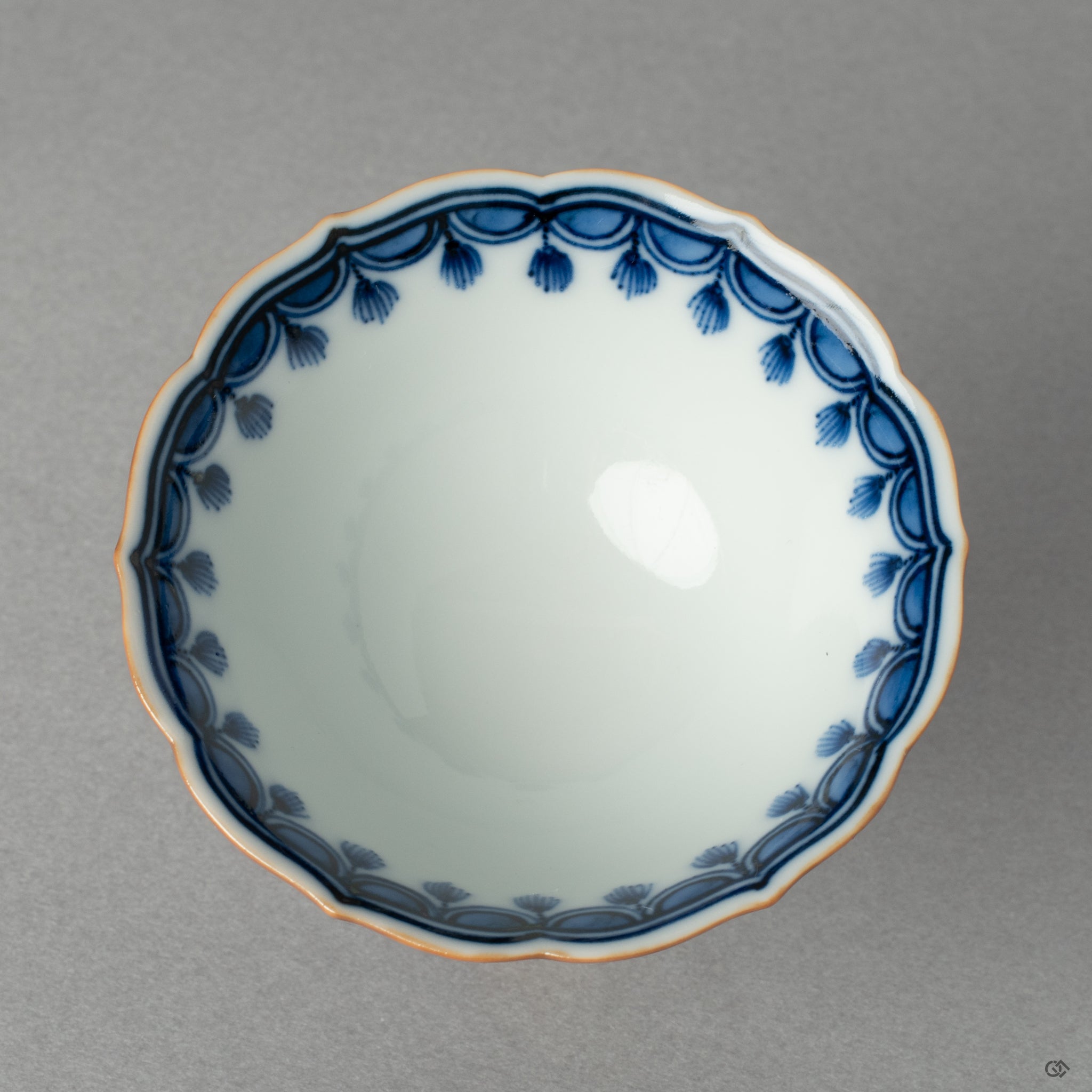 Looking down into the Kyoto ware cup without its lid, its elegant form preserved by the kintsugi restoration, inviting a moment of contemplation.