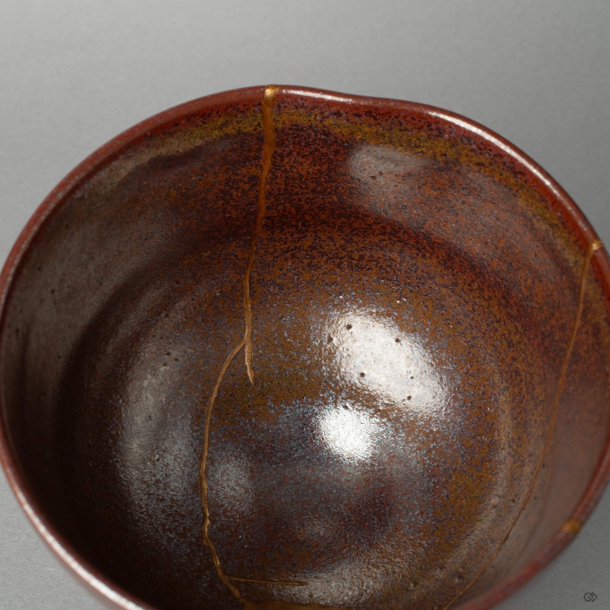 A macro view of the kintsugi seam inside the matcha bowl, telling a silent story in every seam of its thoughtful restoration.