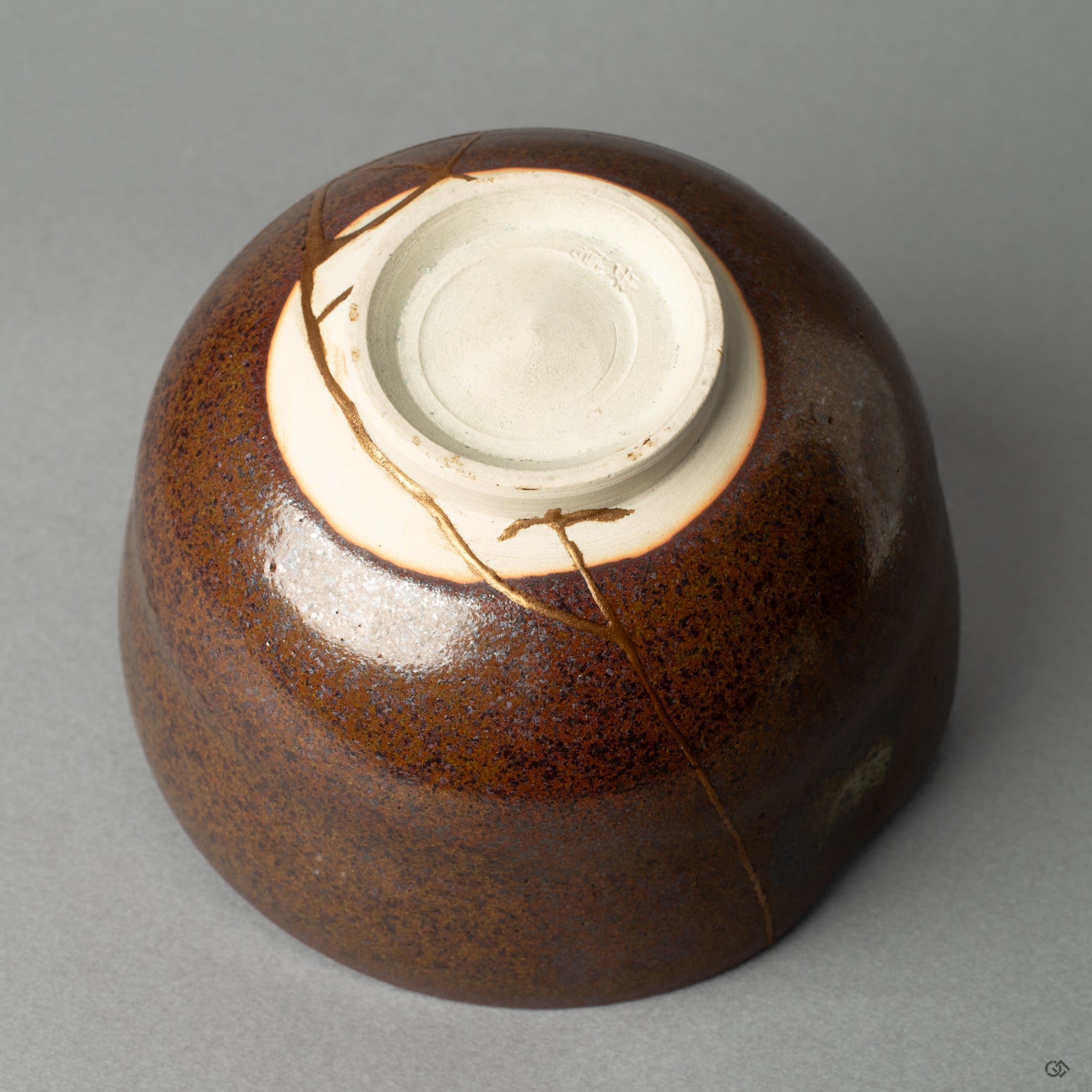 View of the matcha bowls lower form, its graceful curve and kintsugi repair embodying a timeless elegance.