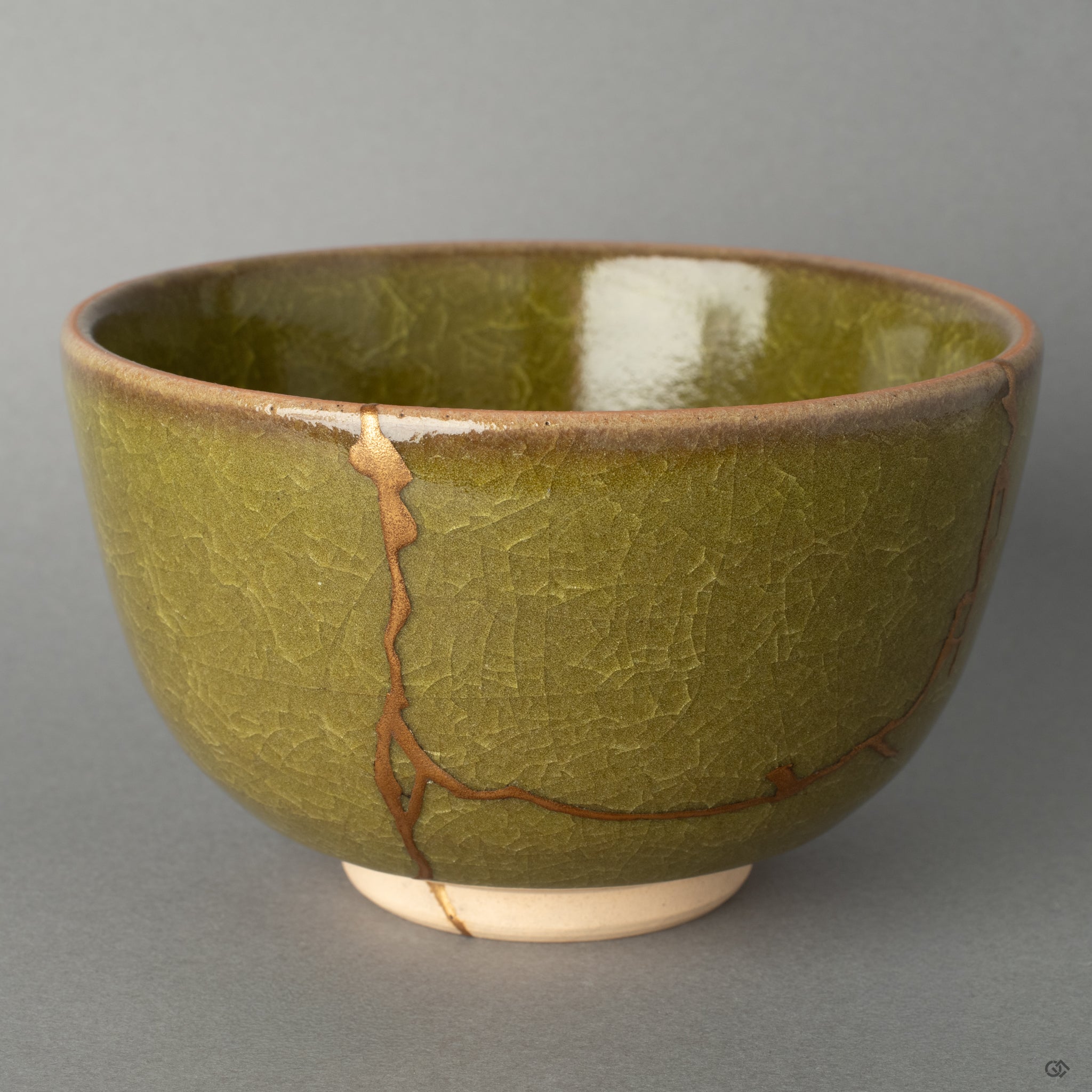 Side view of a kintsugi matcha bowl, the 24K gold seam tracing its form, a profound vision of resilience made beautiful.