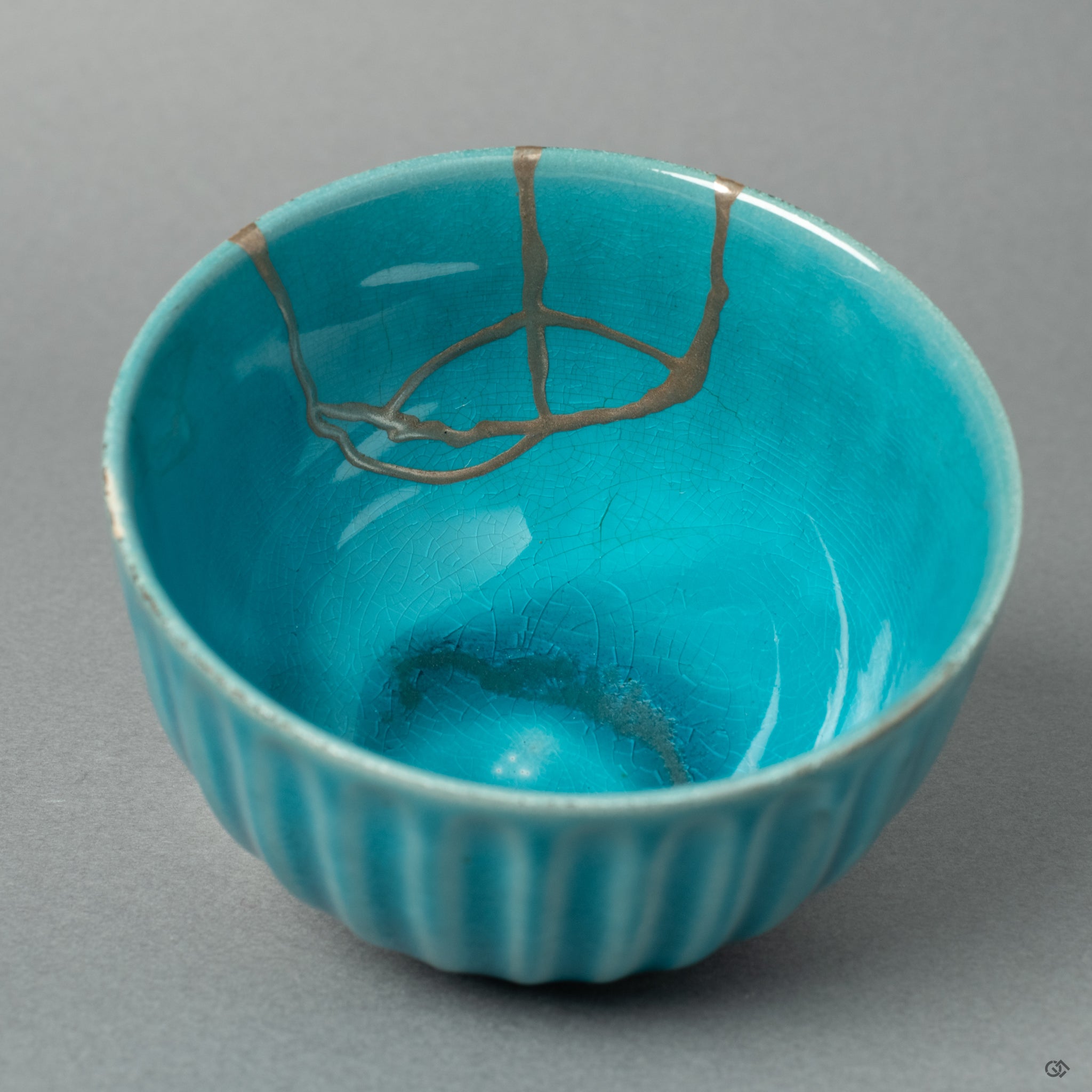 A top-down view into the Arita ware sake cup, revealing a delicate stream of silver Kintsugi flowing across the pristine white porcelain interior—a testament to serene, wabi-sabi elegance.