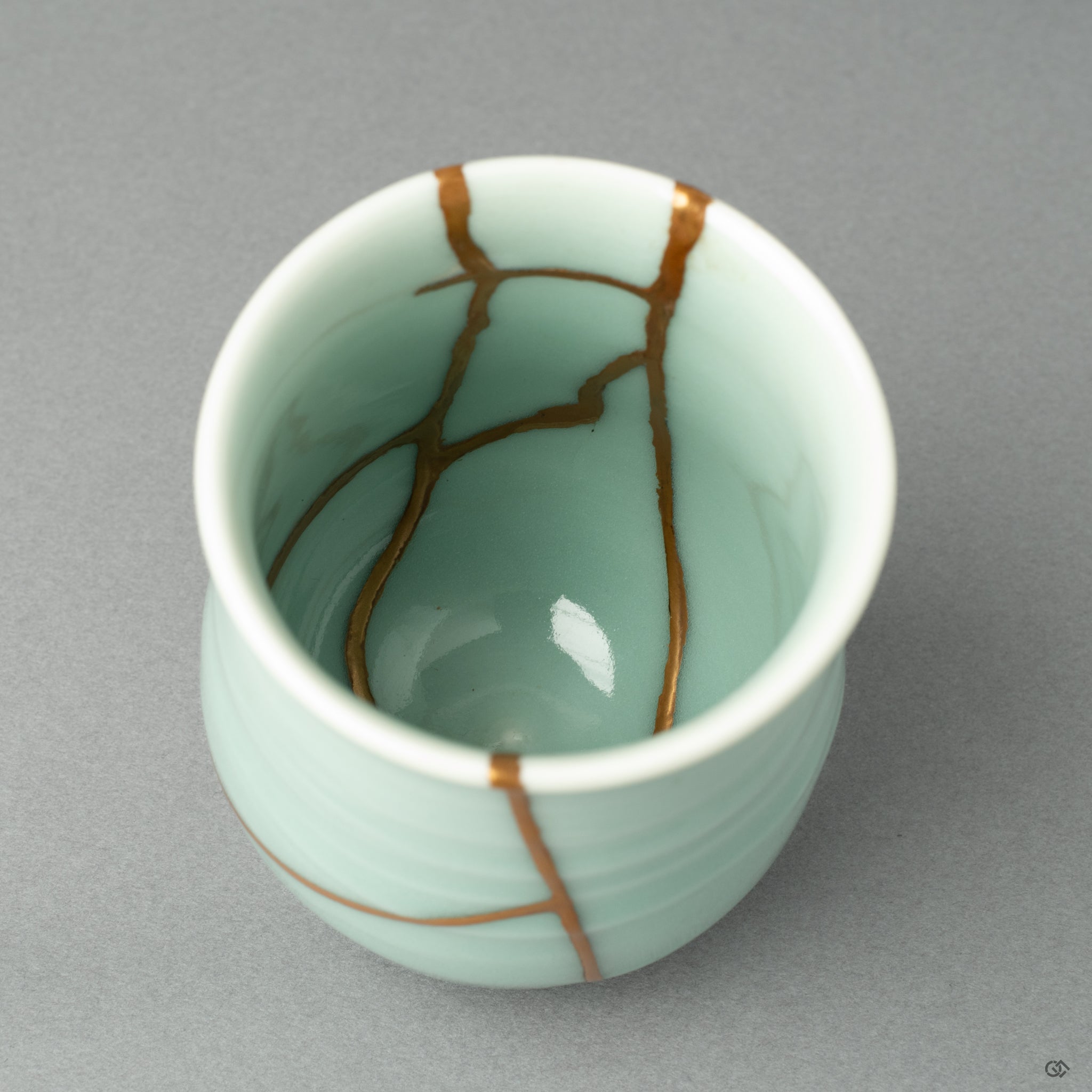 An intricate close-up of the golden joinery, showcasing the masterful Japanese craftsmanship that honors the life of this historic object.