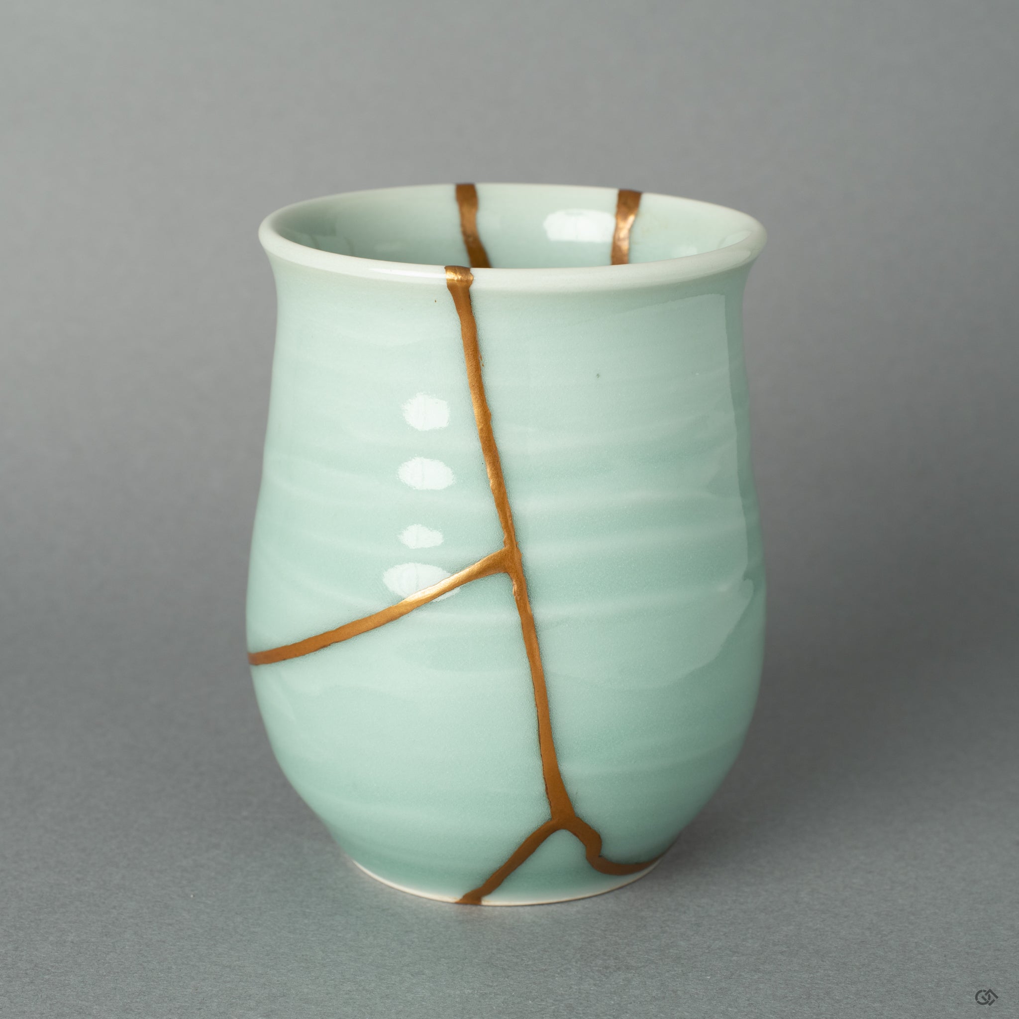 A view of the golden repair's delicate path, a testament to the wabi-sabi philosophy of finding profound beauty in an object's unique story.