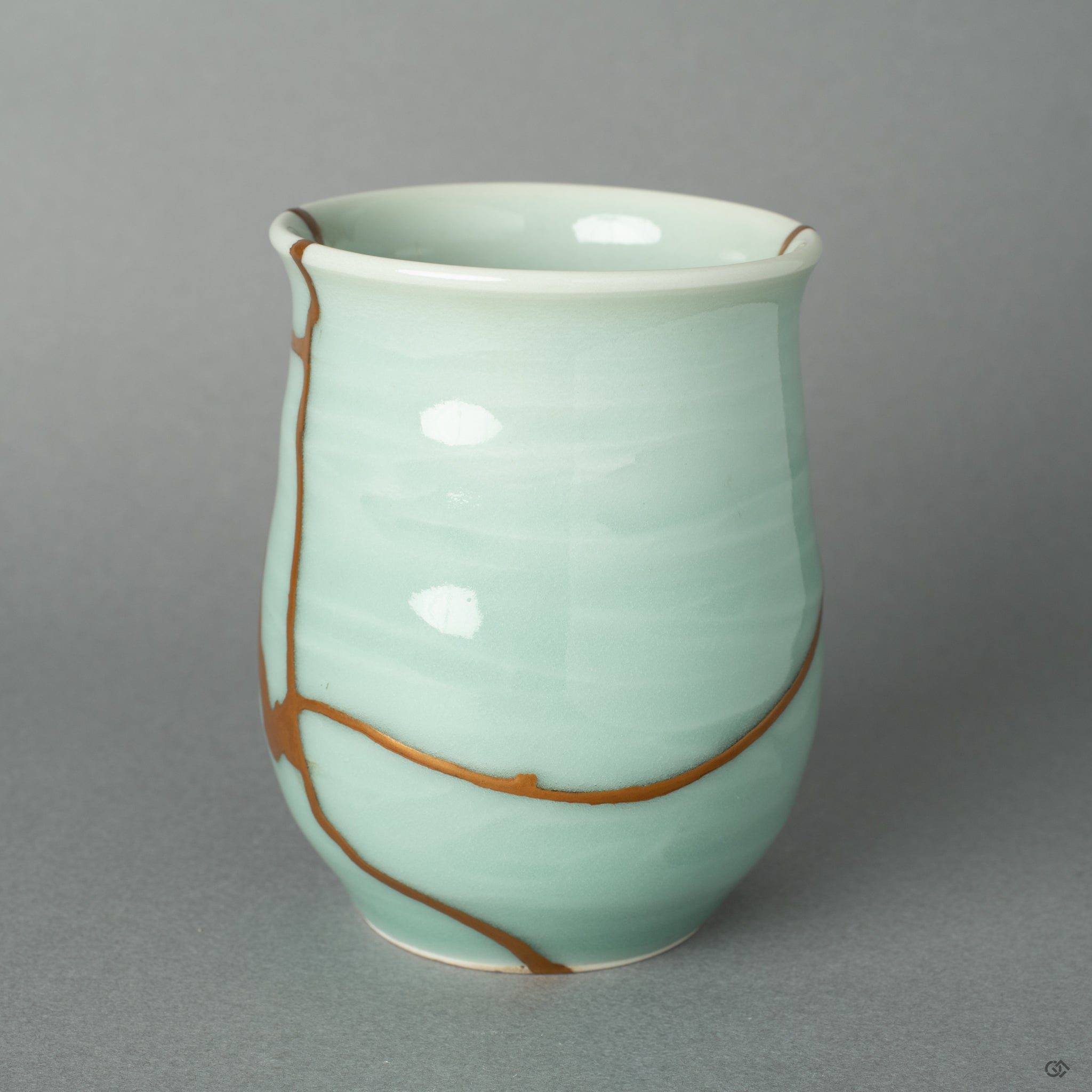 A macro detail of the lustrous 24k gold, highlighting the quiet beauty and authenticity of the traditional Kintsugi restoration.