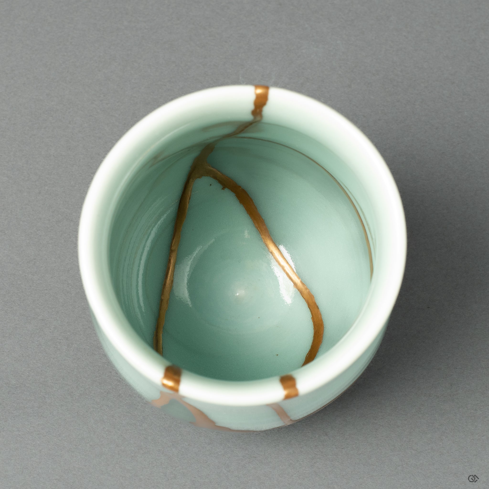 Top-down view of the Nabeshima ware tea cup, showcasing the elegant journey of the 24k gold seam across the rim and into the vessel's interior.