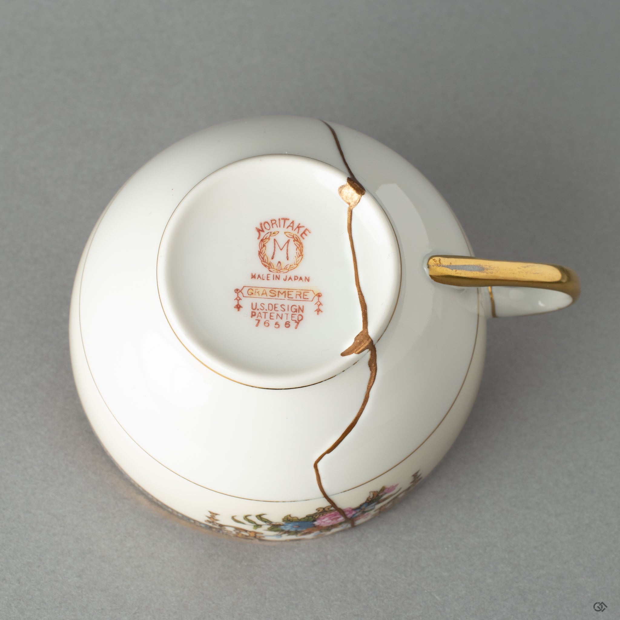 Bottom view of a Kintsugi-repaired Early Noritake tea cup, a testament to a philosophy of care and mindful object creation.