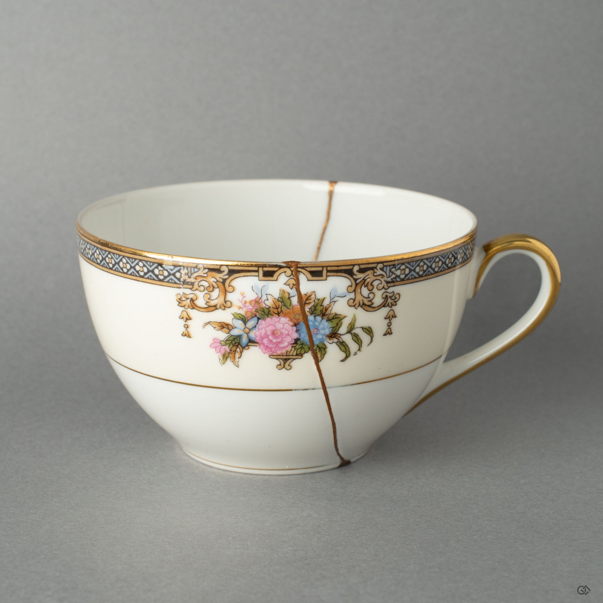 Full front view of a Kintsugi-mended Early Noritake tea cup, showcasing its timeless elegance and history made visible through gold.