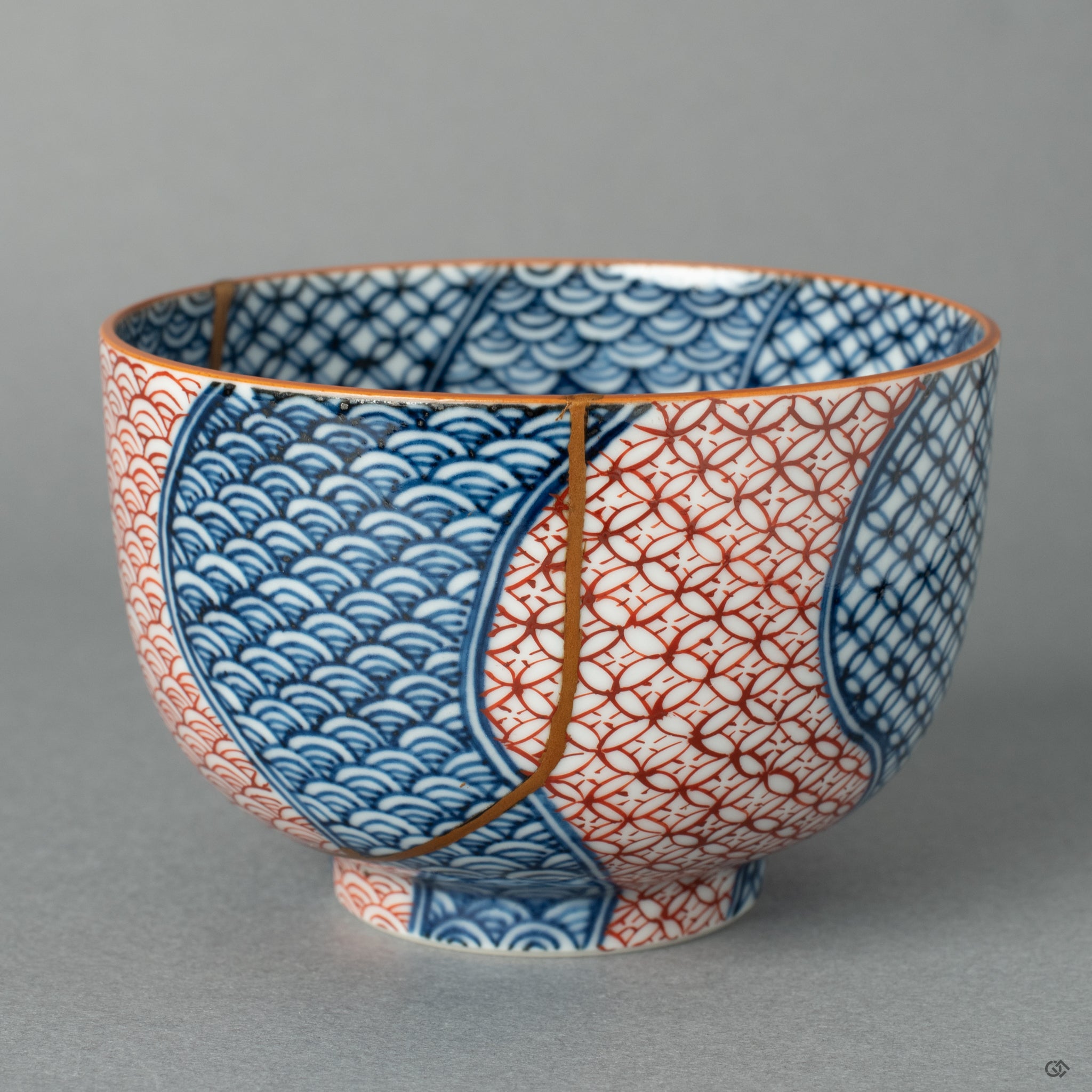 Detail view of the 24k gold Kintsugi on an authentic Kyoto ware tea cup, showing the intricate craftsmanship of the golden joinery.