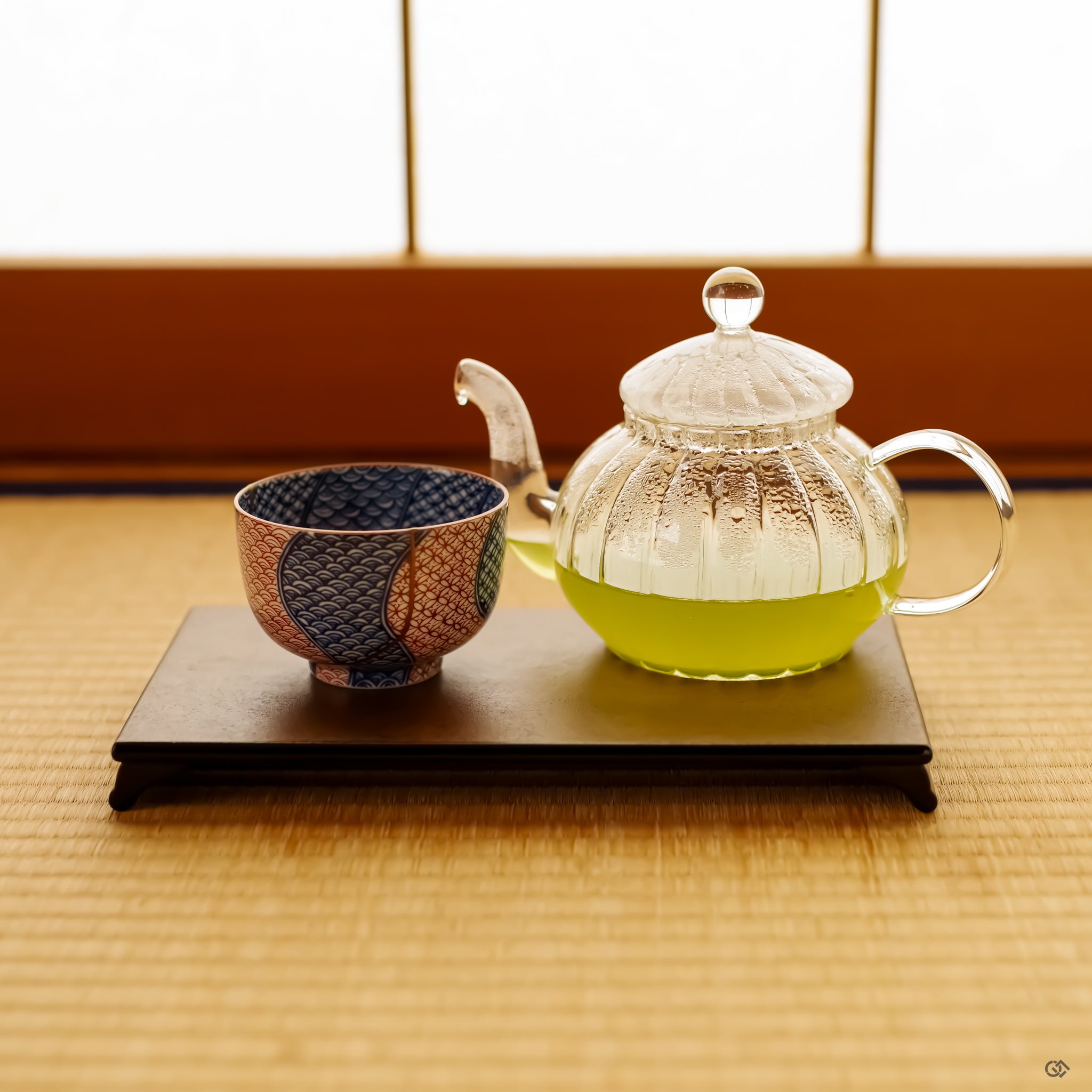 An authentic Kintsugi tea cup in a serene lifestyle setting, placed thoughtfully in a Japanese-style room with shoji screens in the background.