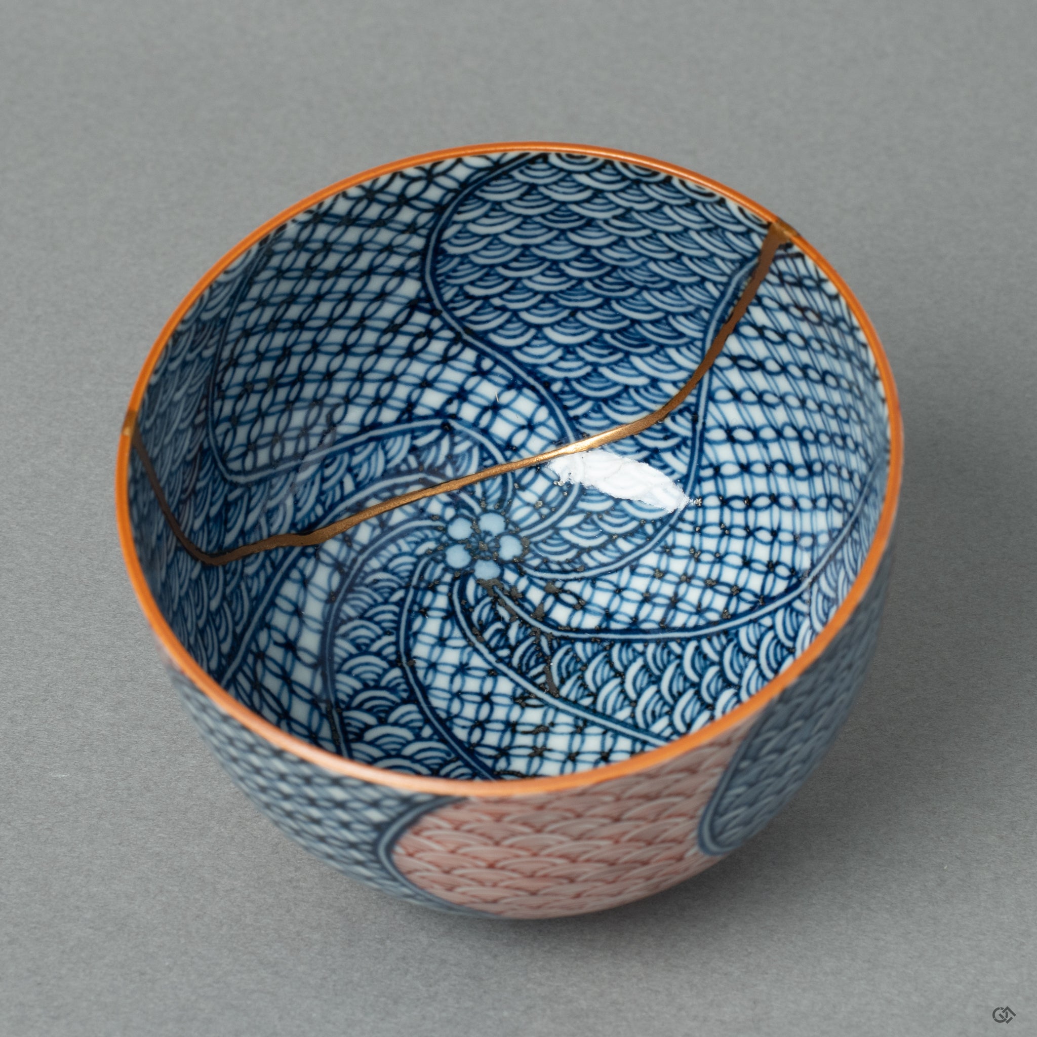 Top-down view of a Kyoto ware tea cup, revealing the elegant 24k gold Kintsugi seam as it traces across the rim and into the vessel's interior.