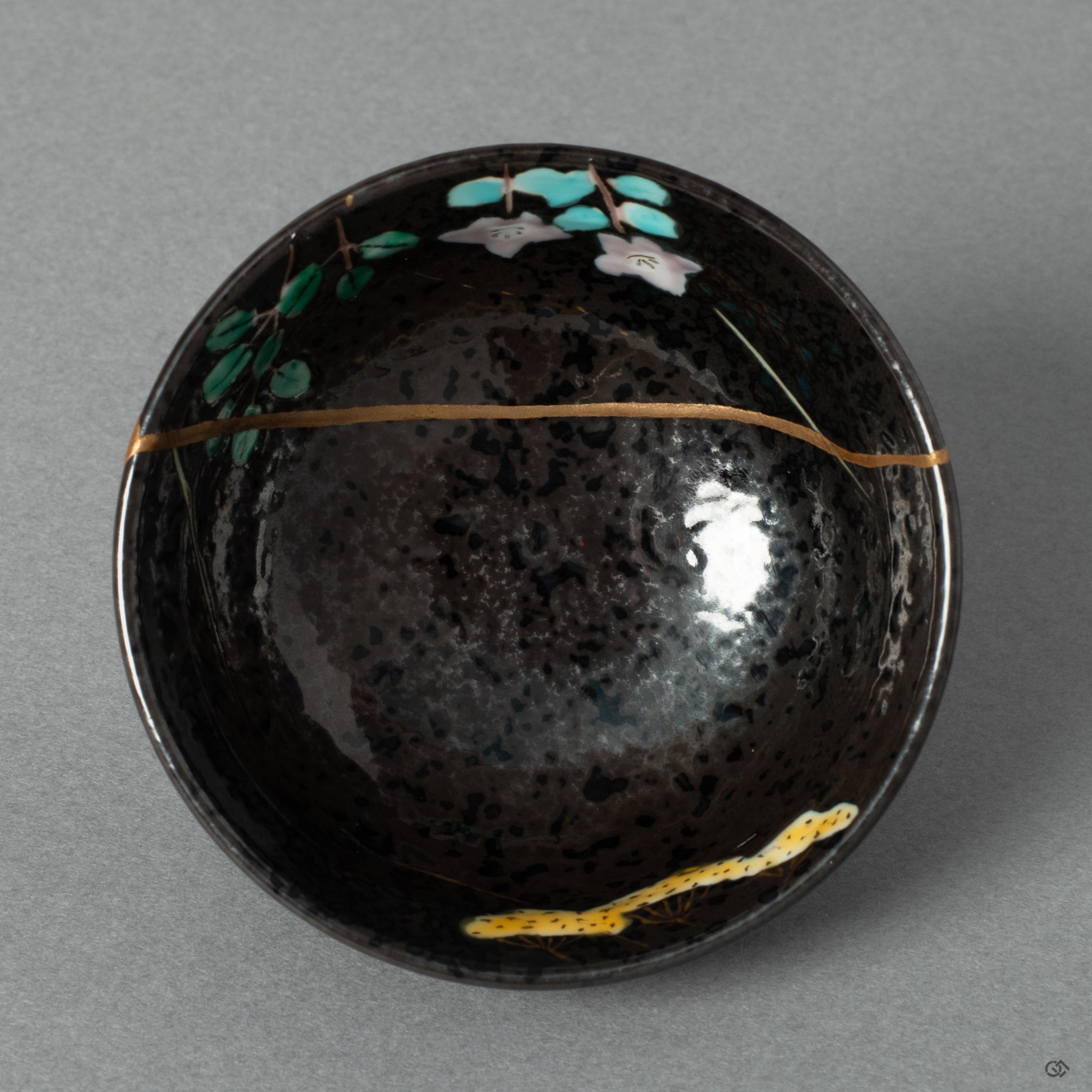 A top-down view into the Arita porcelain cup, its golden repair inviting a moment of contemplation before the cup is filled.