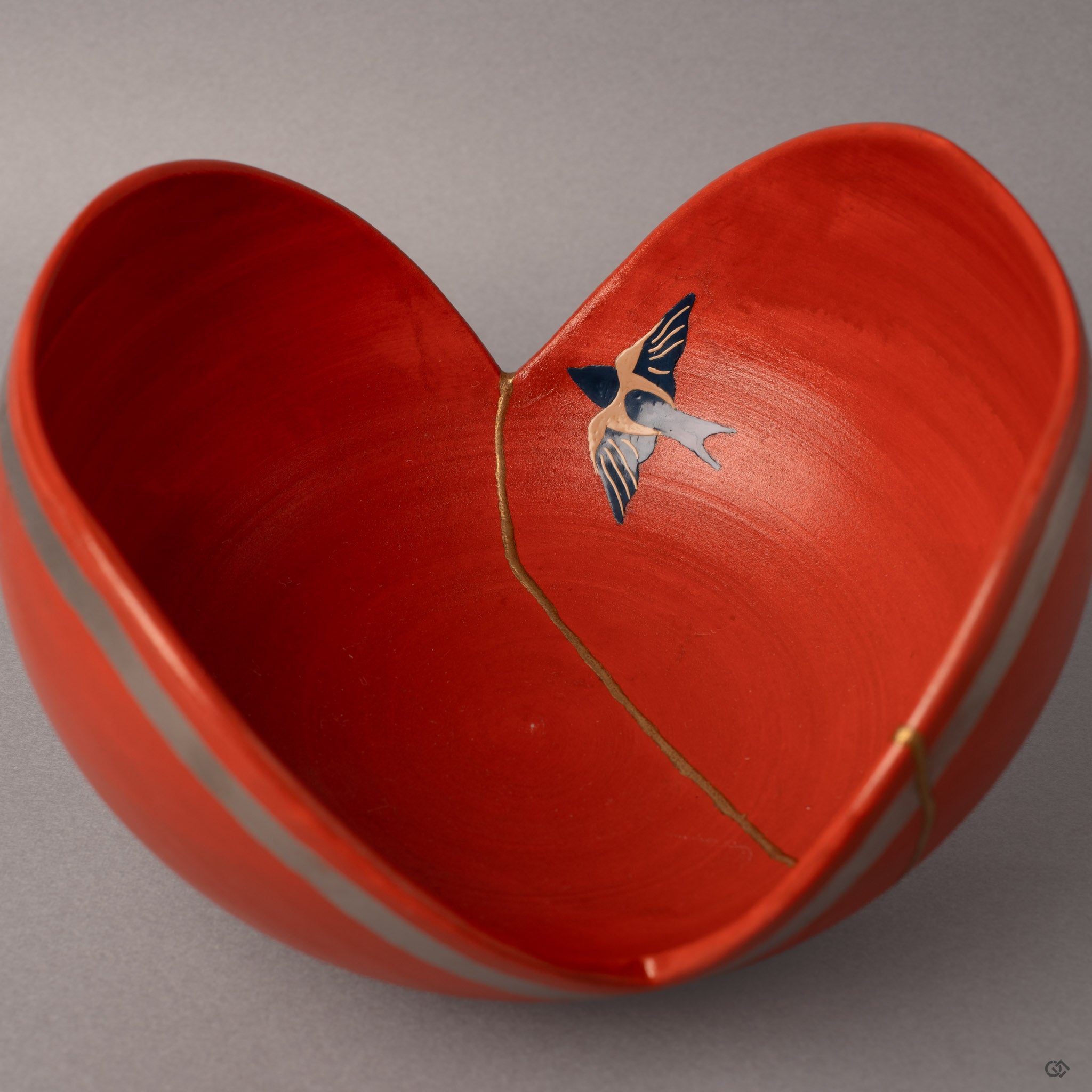 The urushi-e swallow emerges in lacquer paint beside gold kintsugi seams—two ancient arts united in one vessel.