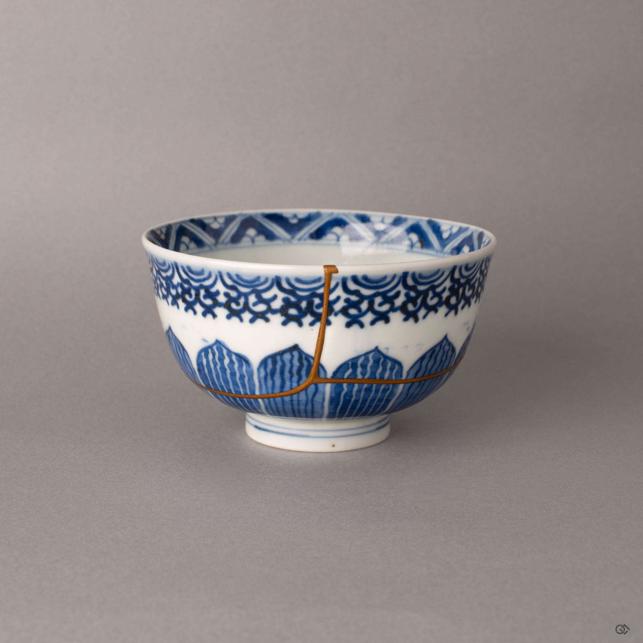 Kintsugi Ko-Imari porcelain bowl front view with gold seams crossing hand-painted sometsuke botanical motifs, a quiet beauty rooted in craft.