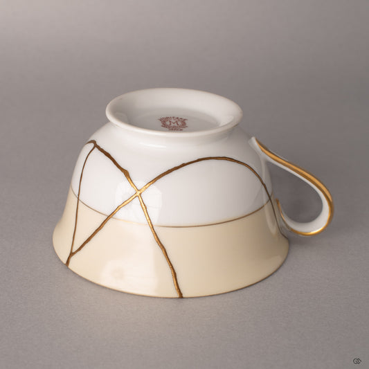 Warm light catches 24K gold kintsugi where vintage Noritake was mended, history made luminous.