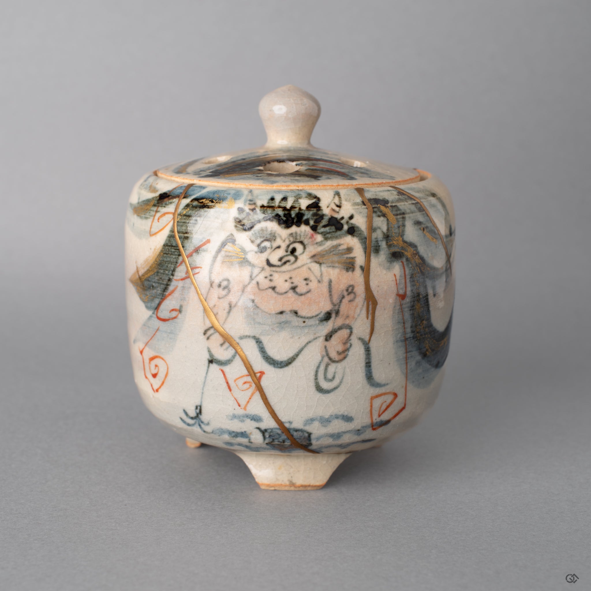 Front view of the Kyoto incense burner restored with 24K gold kintsugi. Gray pottery holding a solemn grace in flaws.
