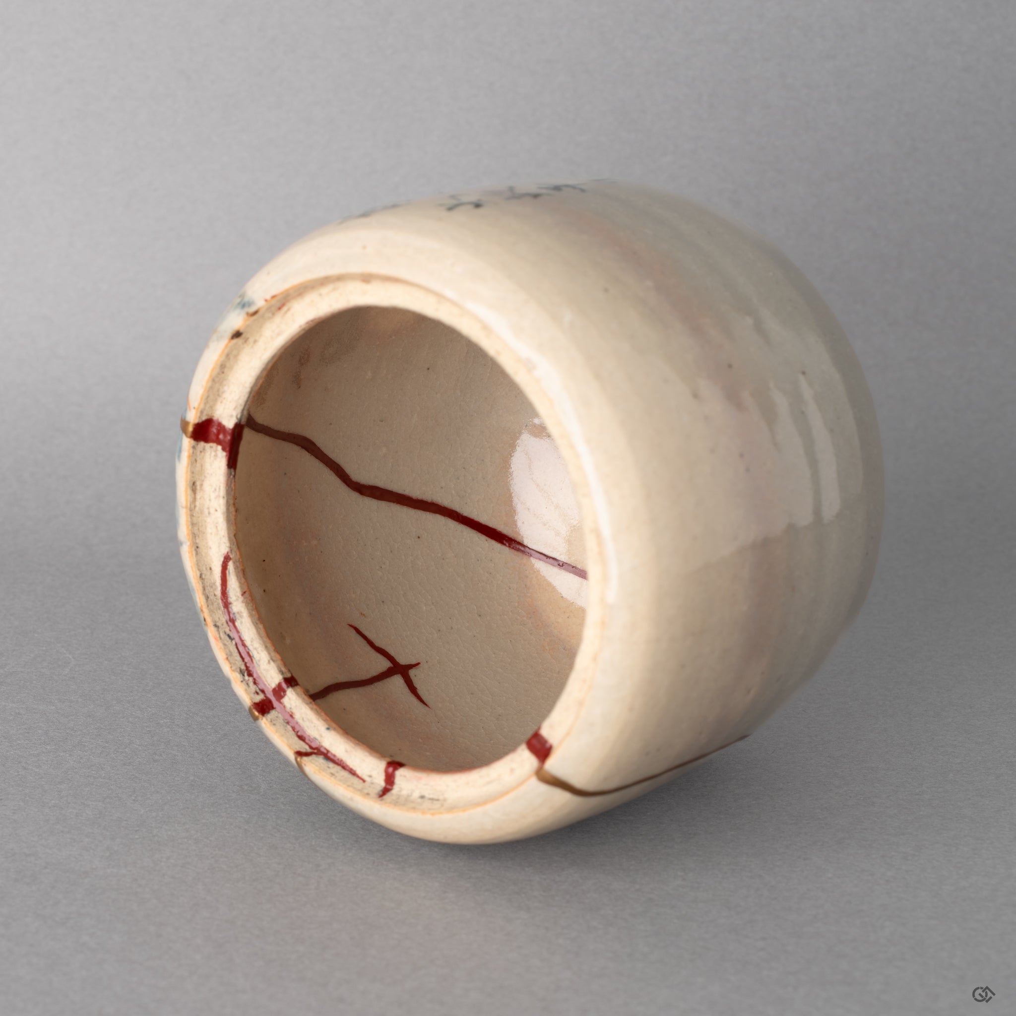 Interior close up of the vermillion urushi restoration. The kintsugi work holds a quiet inherent spiritual elegance.