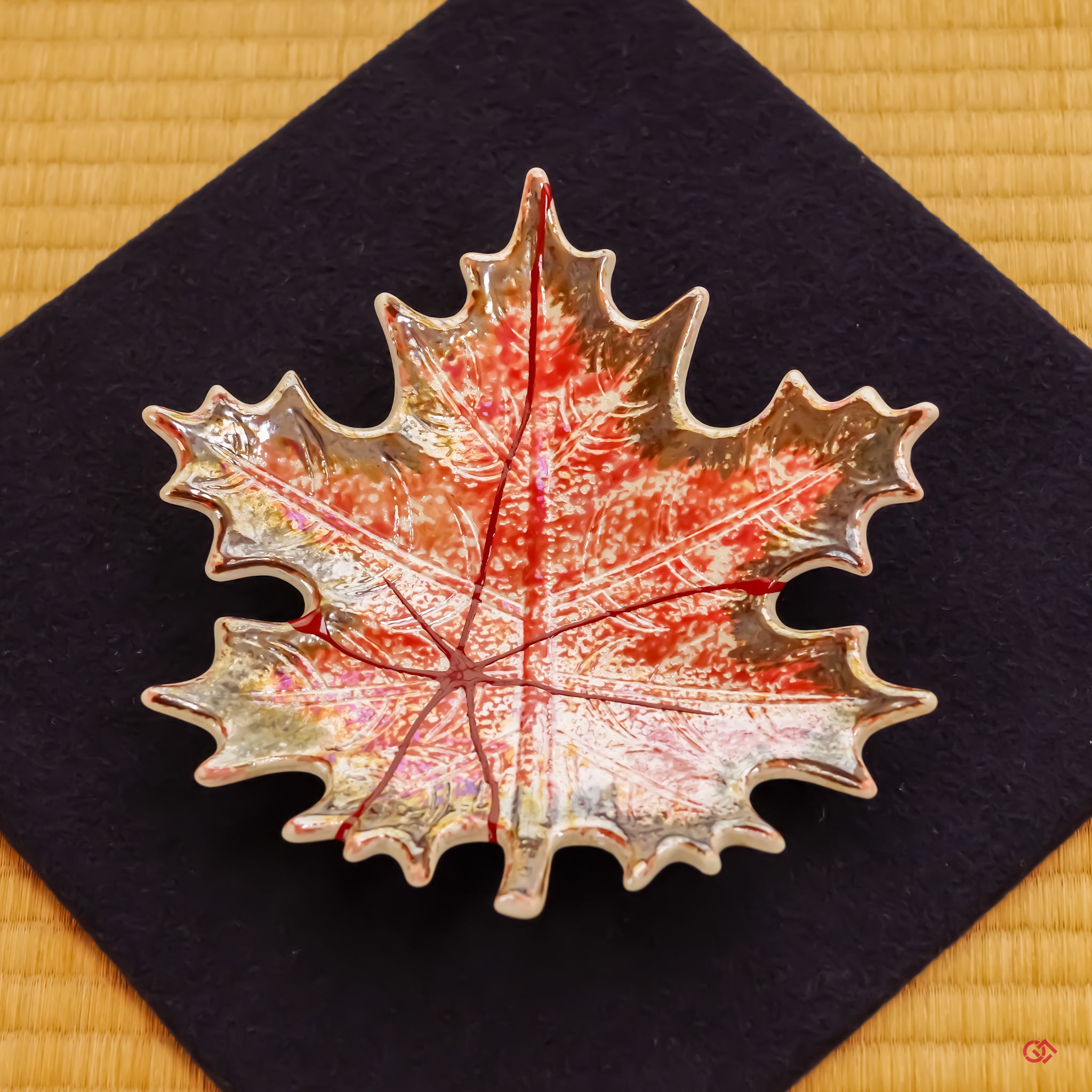 A slow-panning video showcasing the finished Kintsugi plate resting upon a deep navy blue felt cloth. The elegant presentation highlights the piece's serene presence and its harmony with traditional Japanese aesthetics.