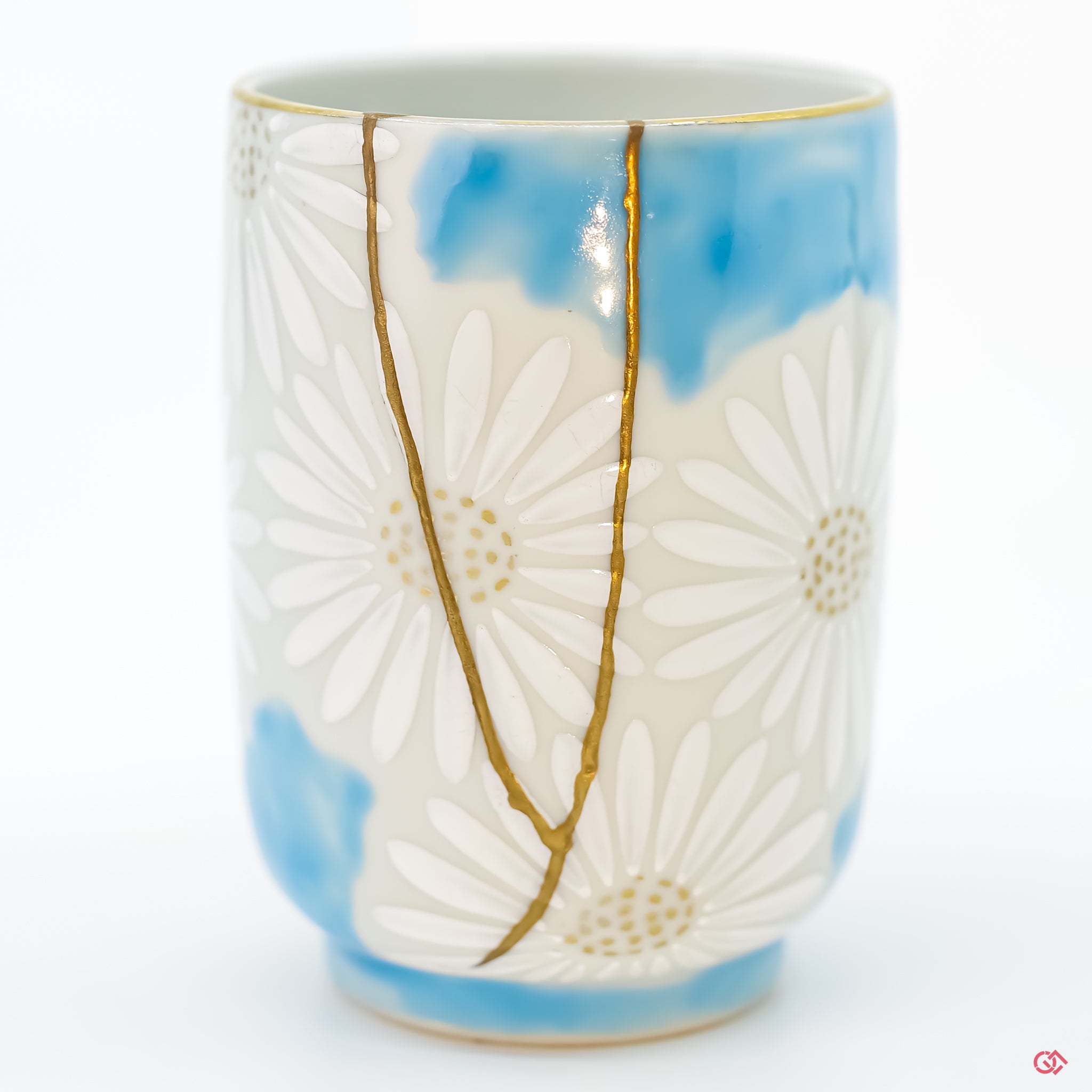 Detail of intricate gold Kintsugi repair on ceramic.