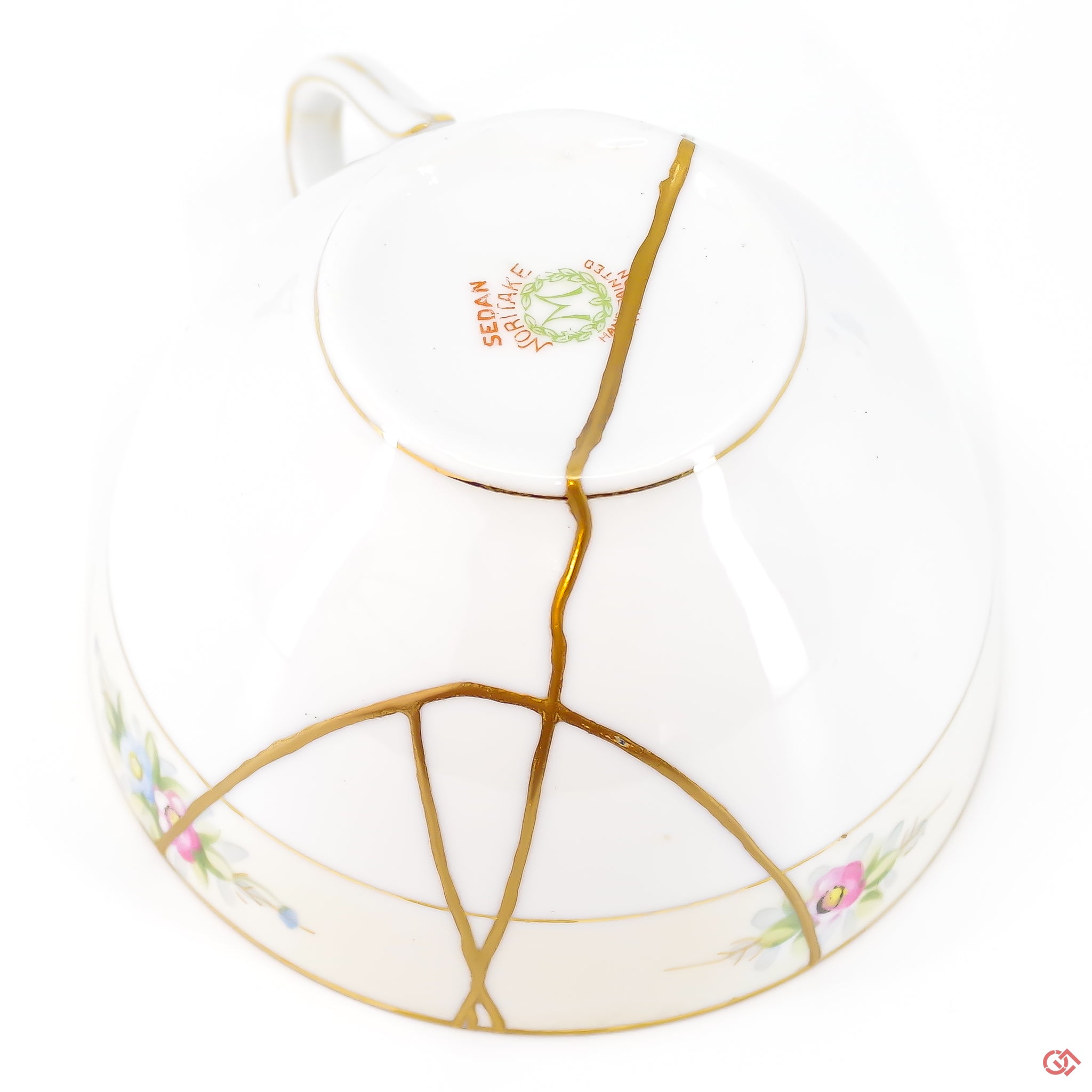 A close-up photo of an authentic Kintsugi pottery piece, showing the detail of its repairs and craftsmanship.