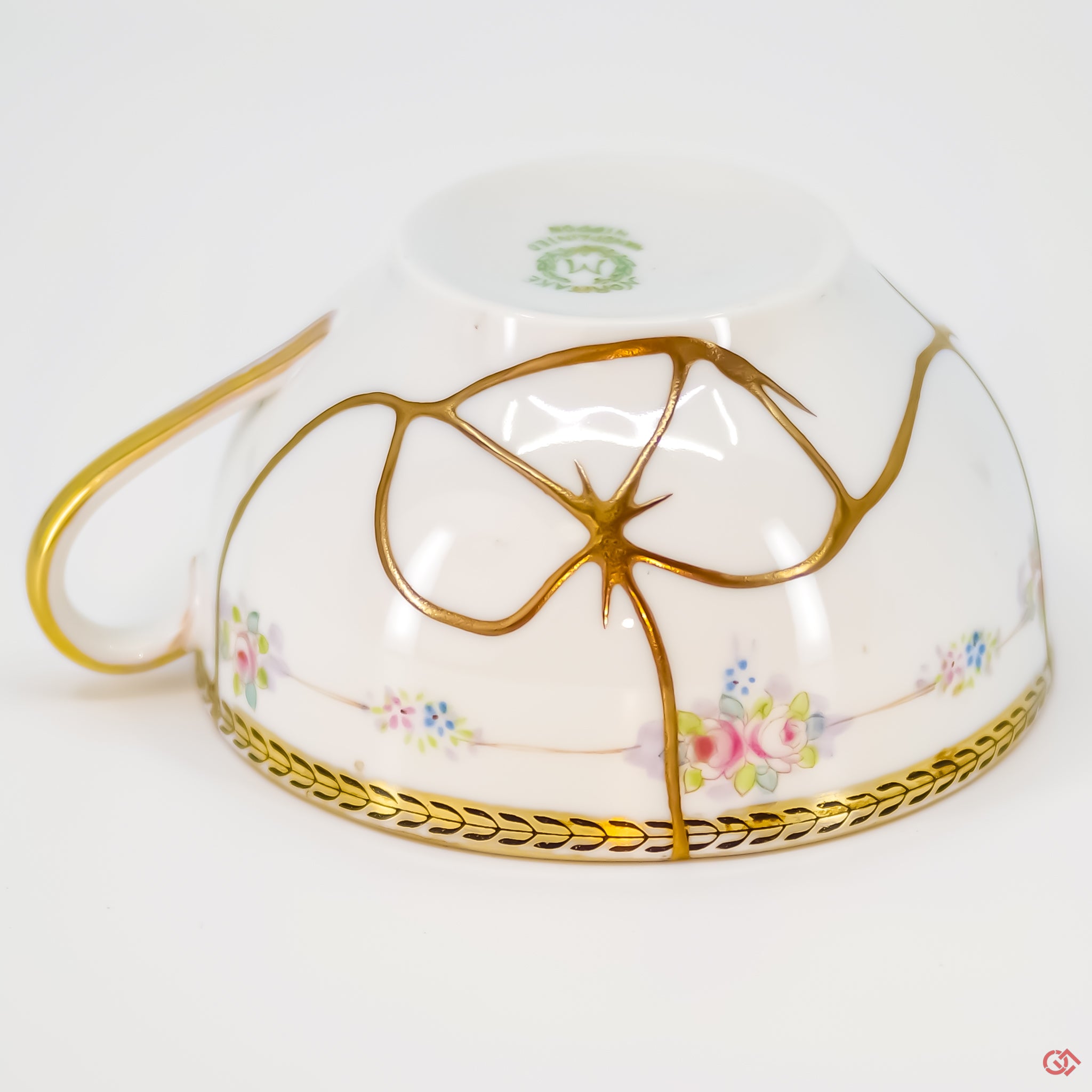 Close-up photo of an authentic Kintsugi pottery piece, showing the detail of its repairs and craftsmanship