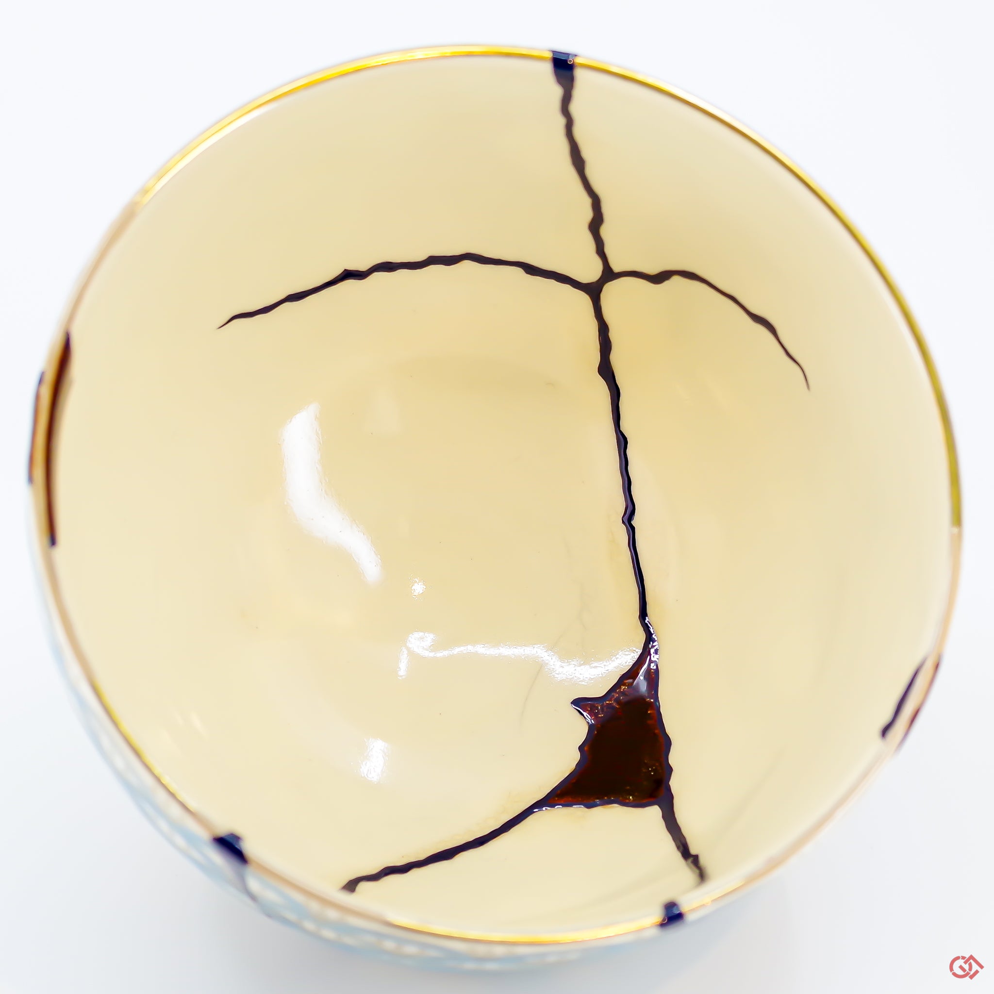 A close-up photo of an authentic Kintsugi pottery piece, showing the detail of its repairs and craftsmanship.