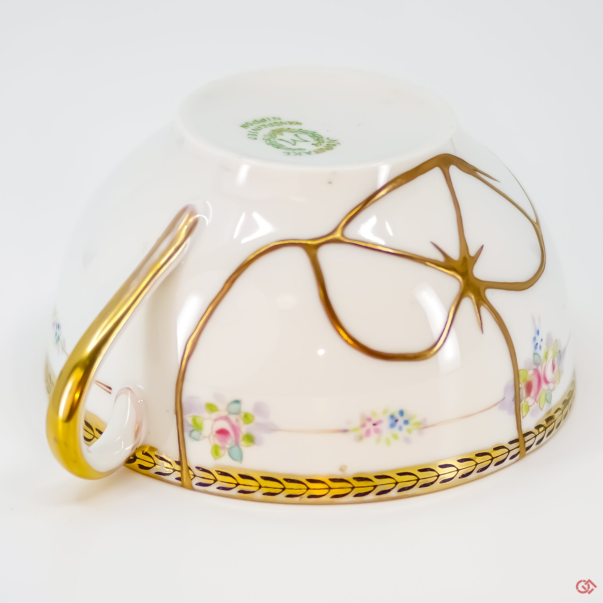 Close-up photo of an authentic Kintsugi pottery piece, showing the detail of its repairs and craftsmanship