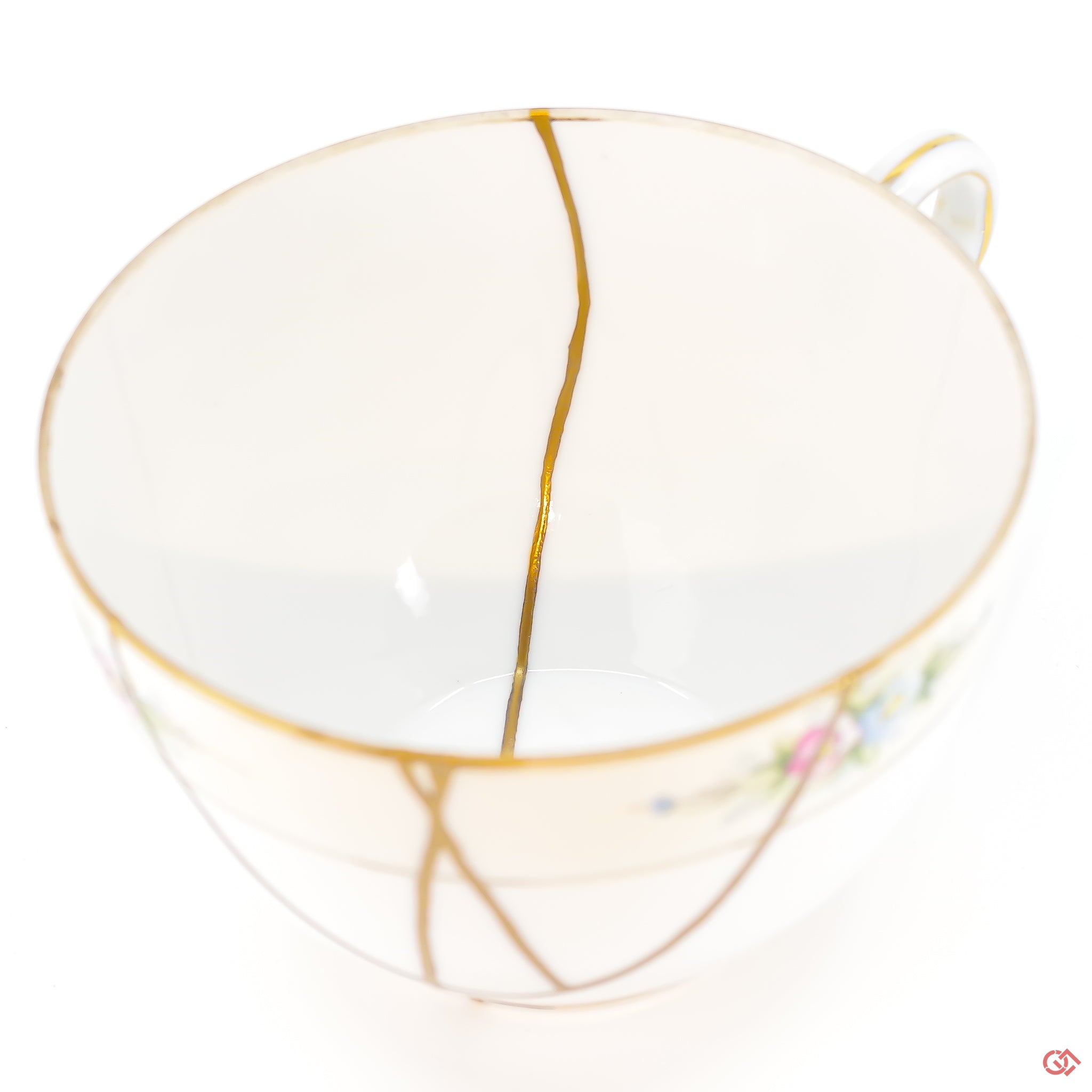 A close-up photo of an authentic Kintsugi pottery piece, showing the detail of its repairs and craftsmanship.